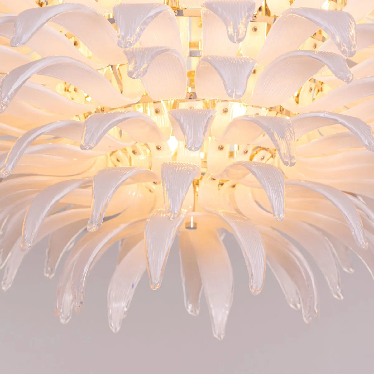 One More Try large chandelier with gold frame and white tinted glass panels illuminating a modern living room