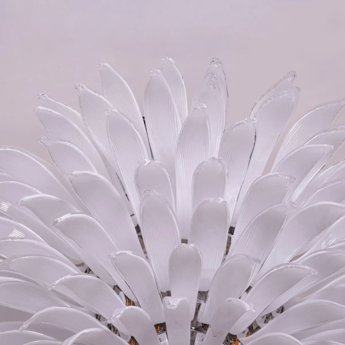 One More Try large chandelier with gold frame and white tinted glass panels illuminating a modern living room