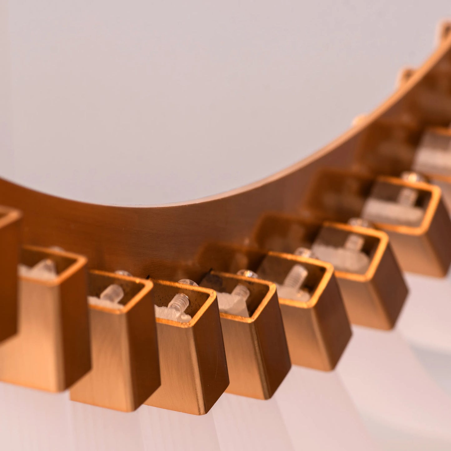 Large gold and white Chefs Kiss chandelier with frosted glass, hanging in a spacious living room