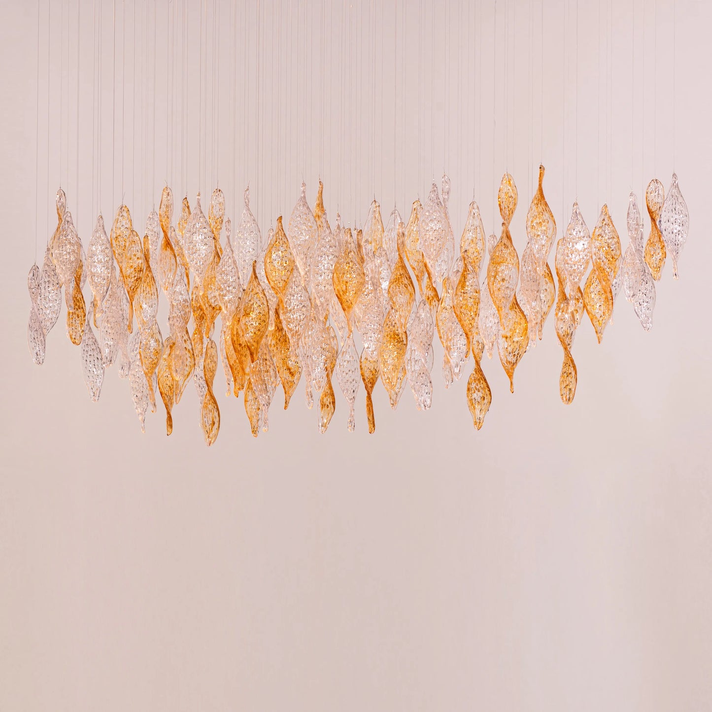 Lazy Sunday double height gold chandelier with textured glass in a grand foyer