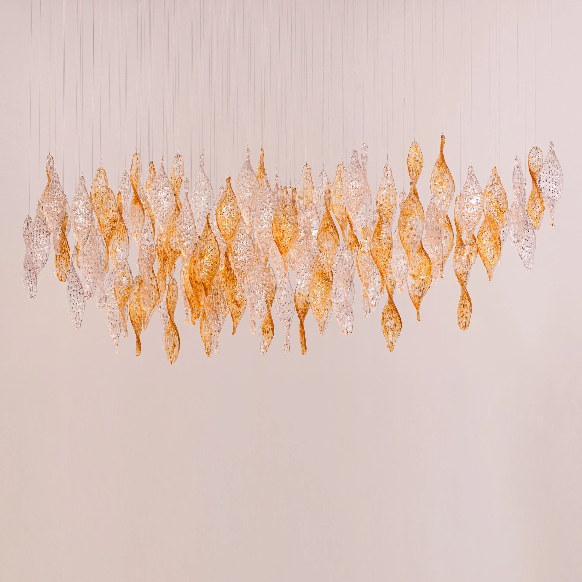 Lazy Sunday double height gold chandelier with textured glass in a grand foyer