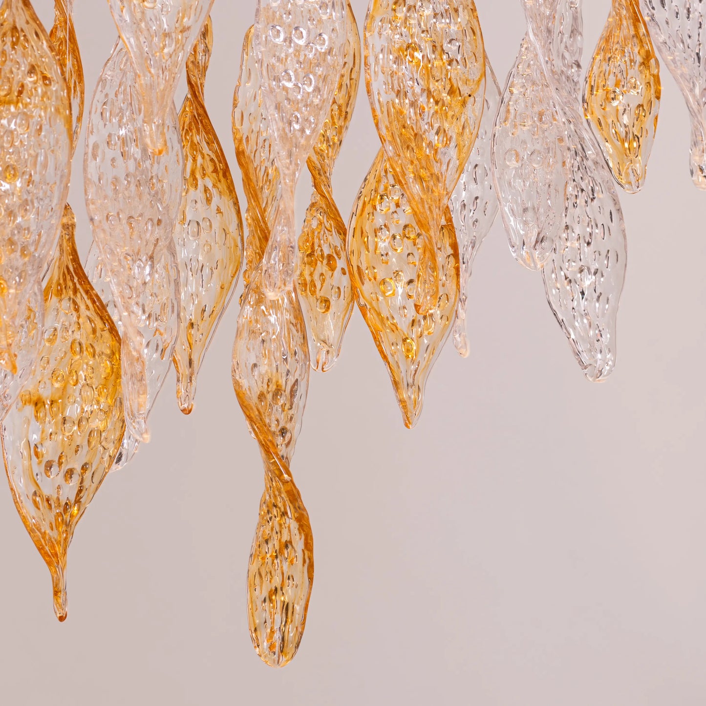 Lazy Sunday double height gold chandelier with textured glass in a grand foyer