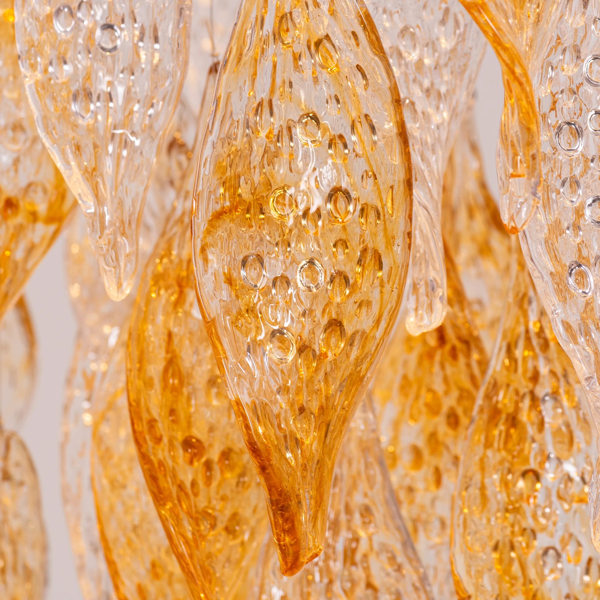 Lazy Sunday double height gold chandelier with textured glass in a grand foyer