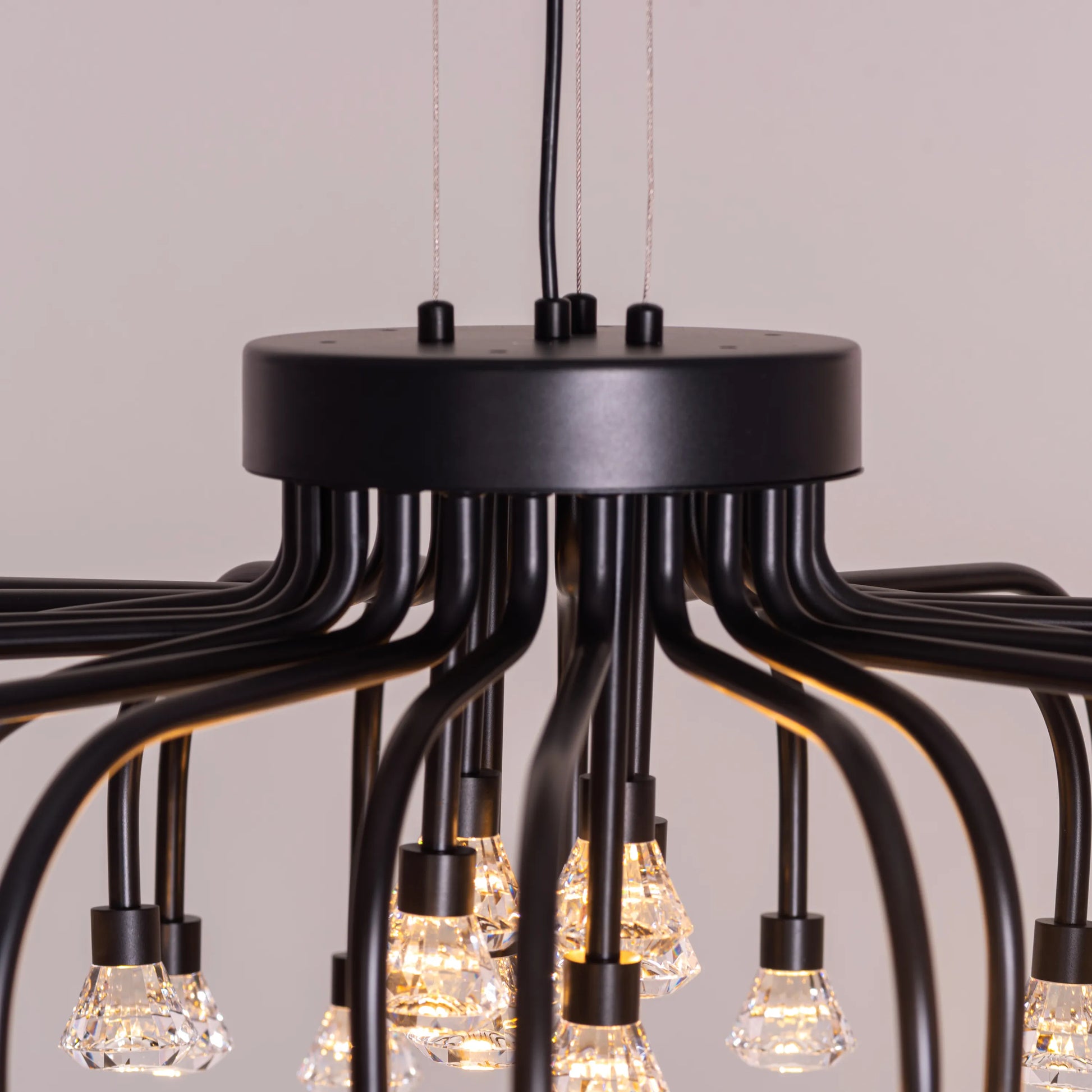 Queen Of Chaos black chandelier with built-in LED lighting.