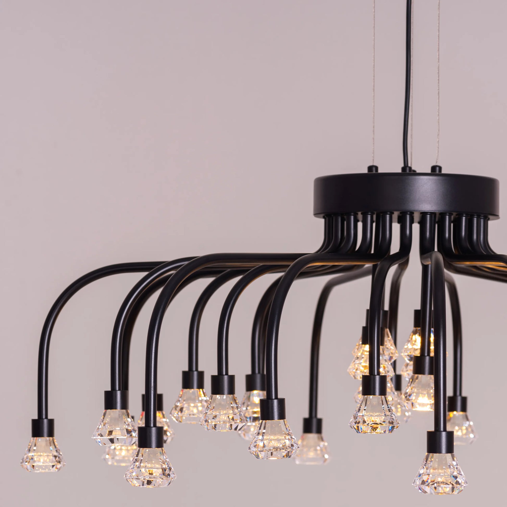 Queen Of Chaos black chandelier with built-in LED lighting.