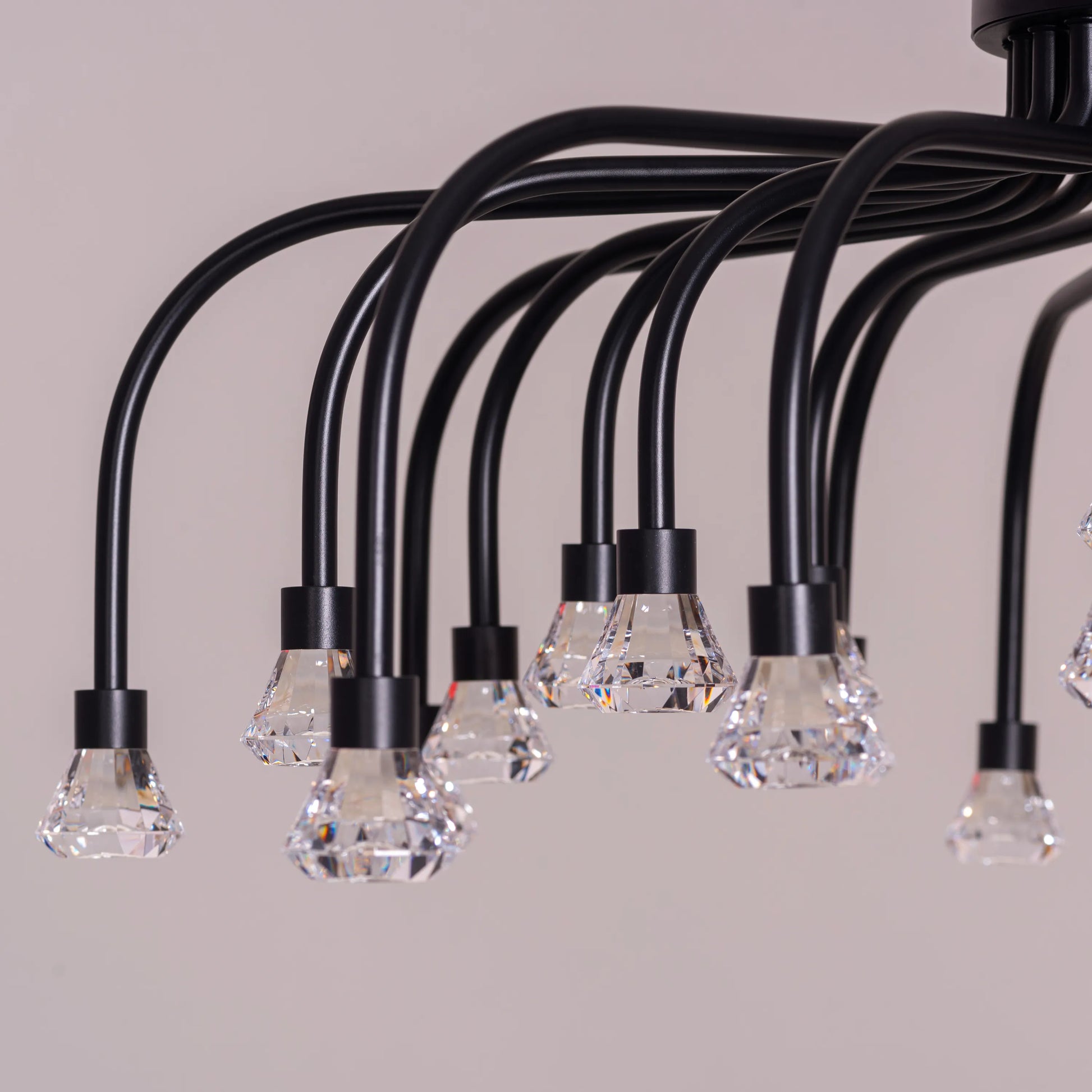 Queen Of Chaos black chandelier with built-in LED lighting.