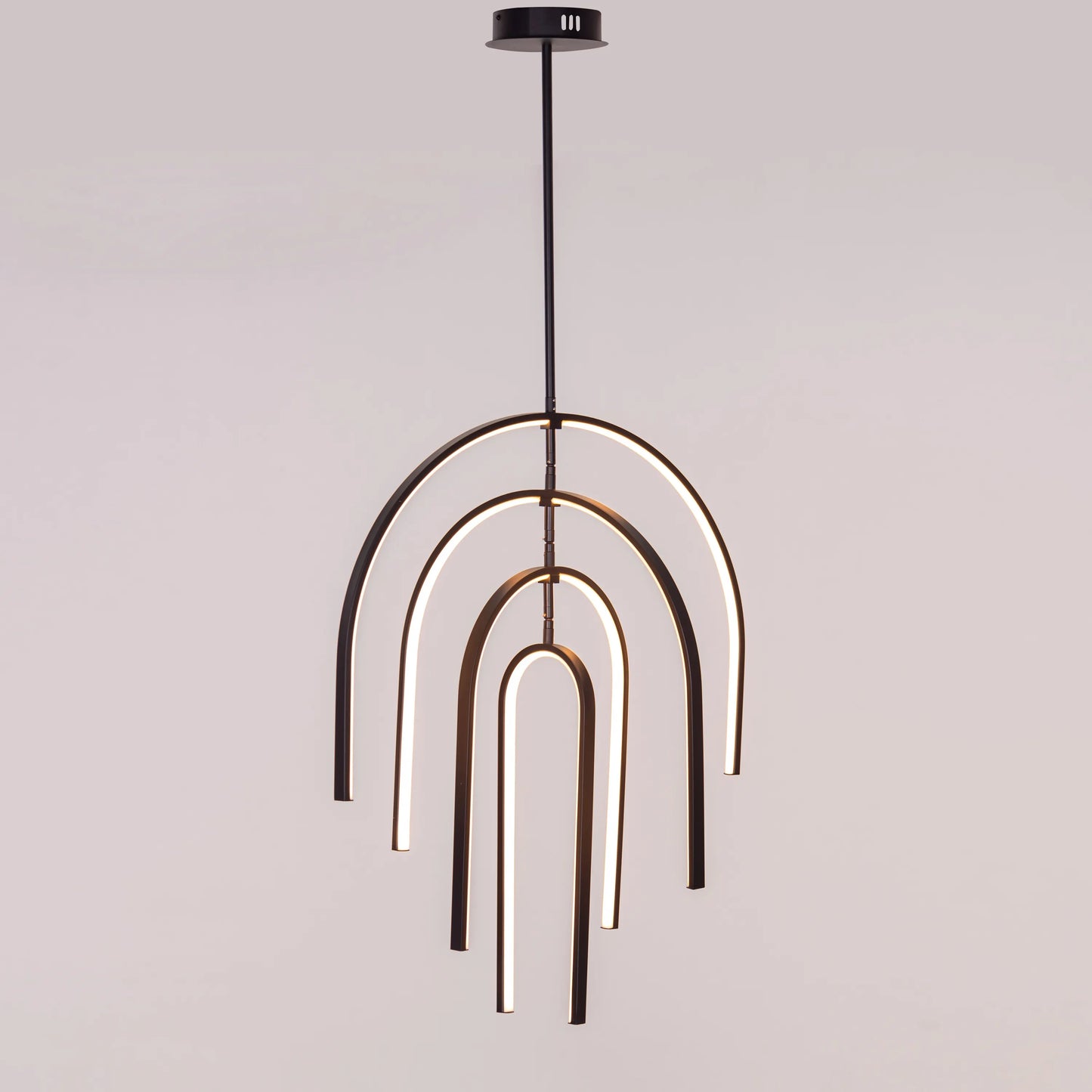 Heatwave Black Chandelier illuminating a room with vibrant amber light, showcasing its unique wave-inspired design