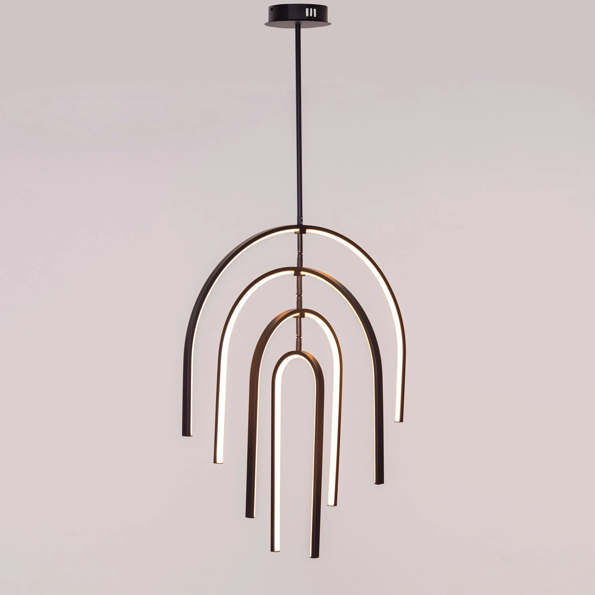 Heatwave Black Chandelier illuminating a room with vibrant amber light, showcasing its unique wave-inspired design