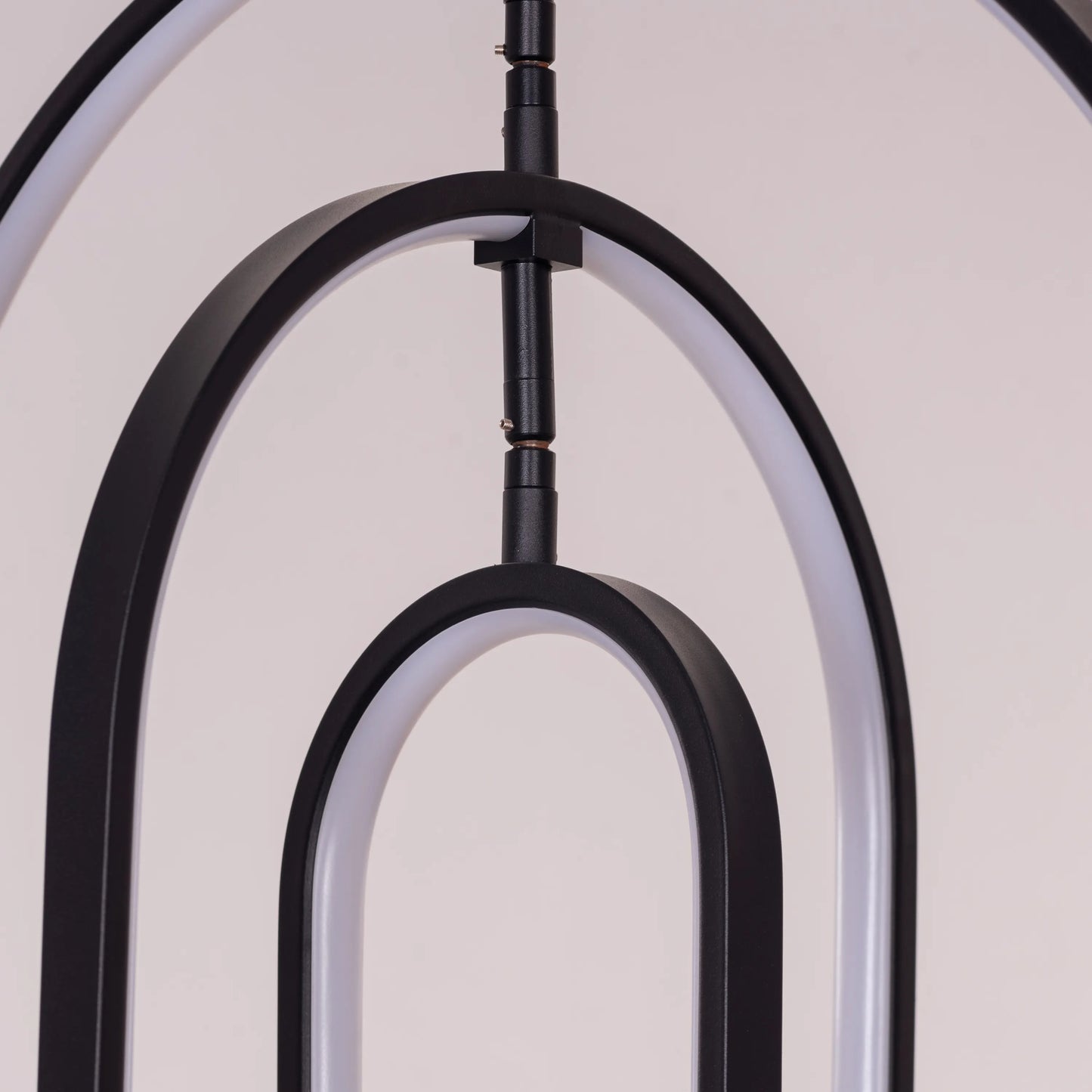 Heatwave Black Chandelier illuminating a room with vibrant amber light, showcasing its unique wave-inspired design