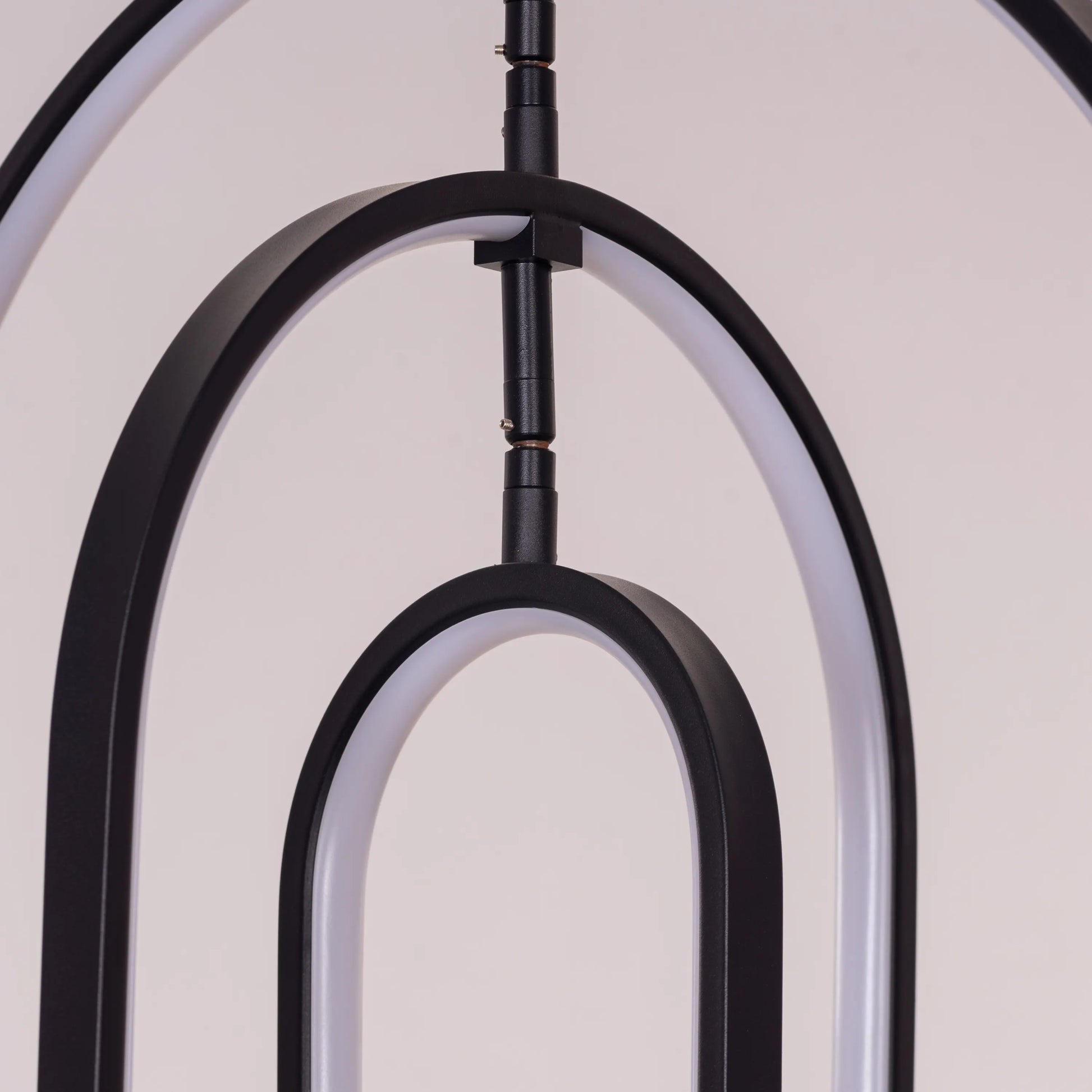 Heatwave Black Chandelier illuminating a room with vibrant amber light, showcasing its unique wave-inspired design