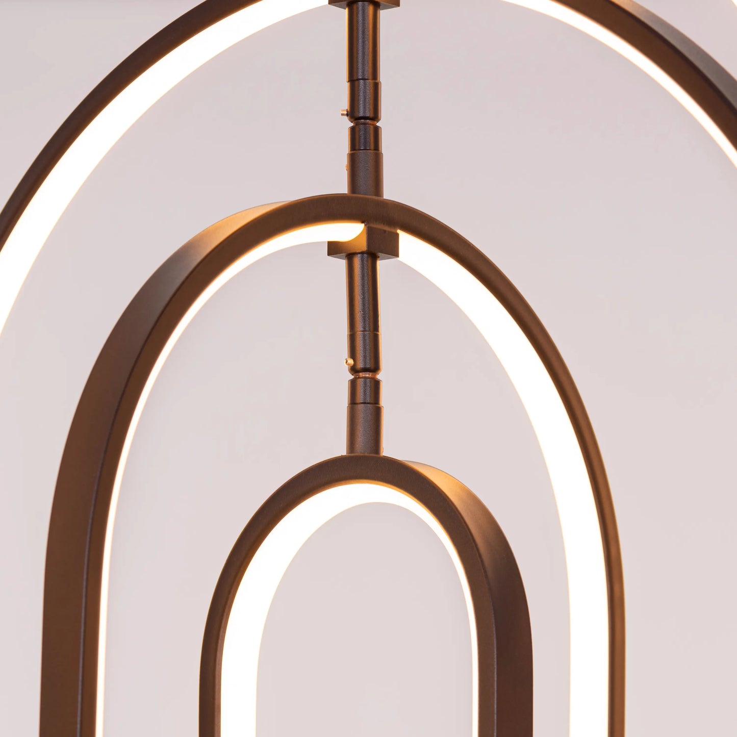 Heatwave Black Chandelier illuminating a room with vibrant amber light, showcasing its unique wave-inspired design