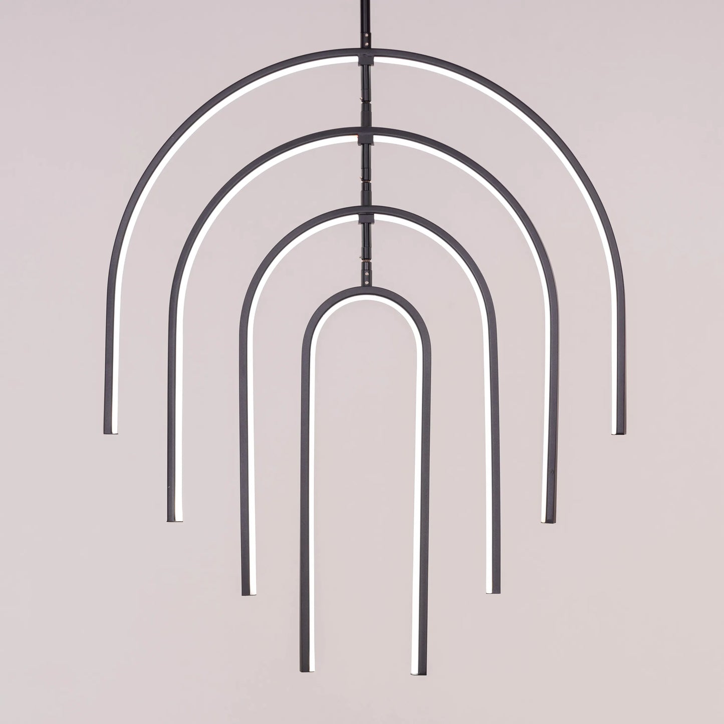 Heatwave Black Chandelier illuminating a room with vibrant amber light, showcasing its unique wave-inspired design