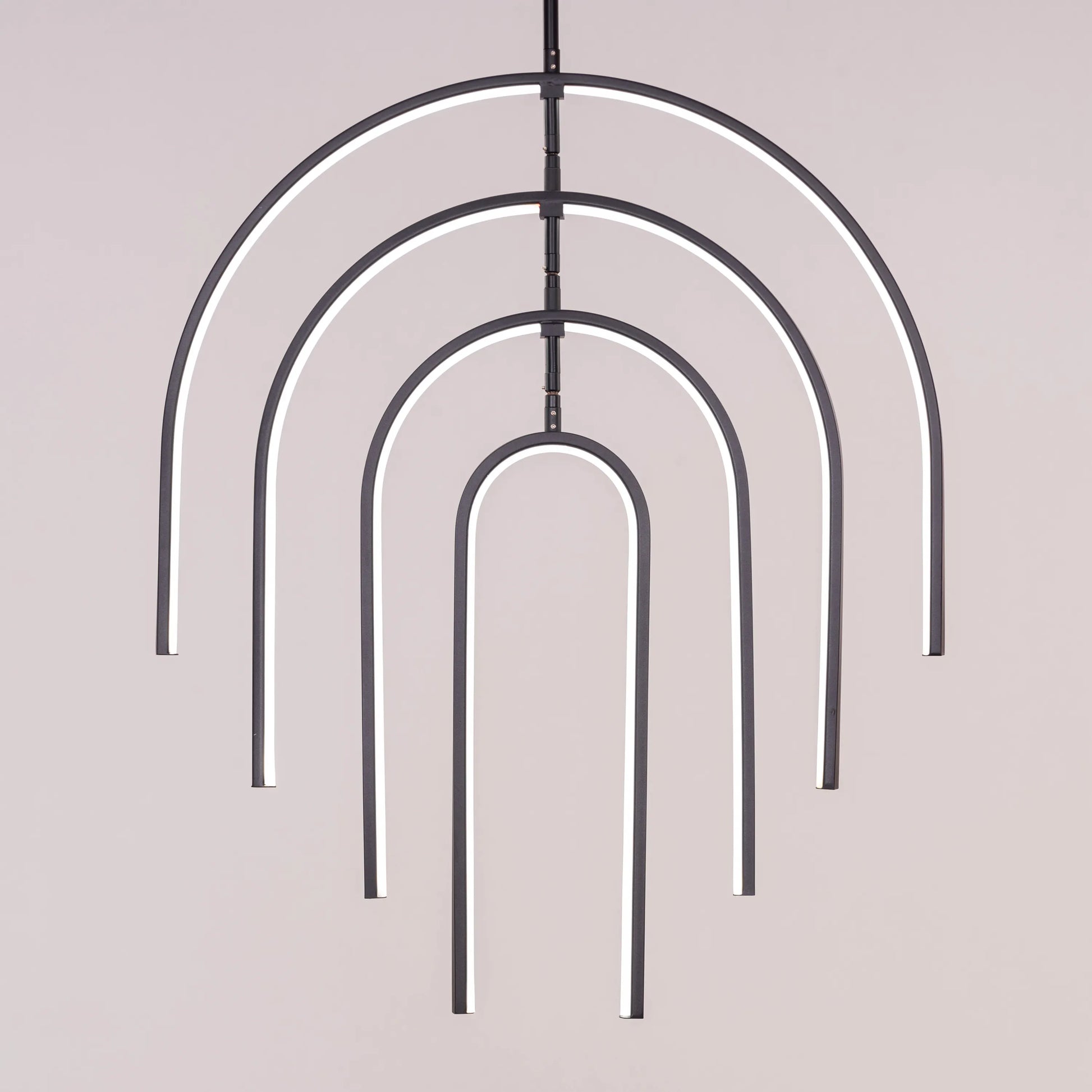 Heatwave Black Chandelier illuminating a room with vibrant amber light, showcasing its unique wave-inspired design