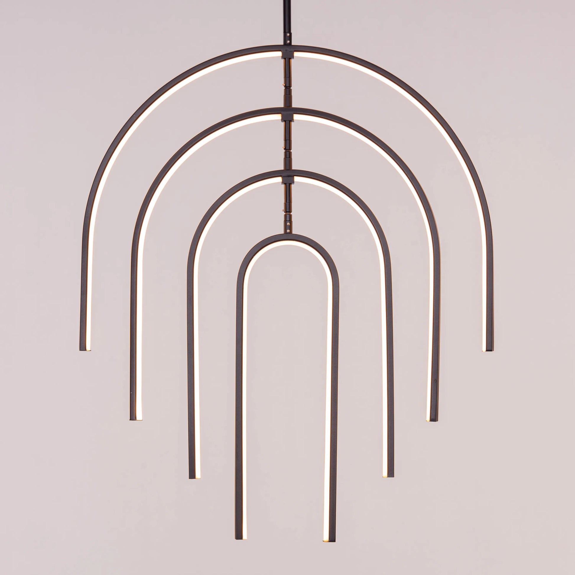 Heatwave Black Chandelier illuminating a room with vibrant amber light, showcasing its unique wave-inspired design