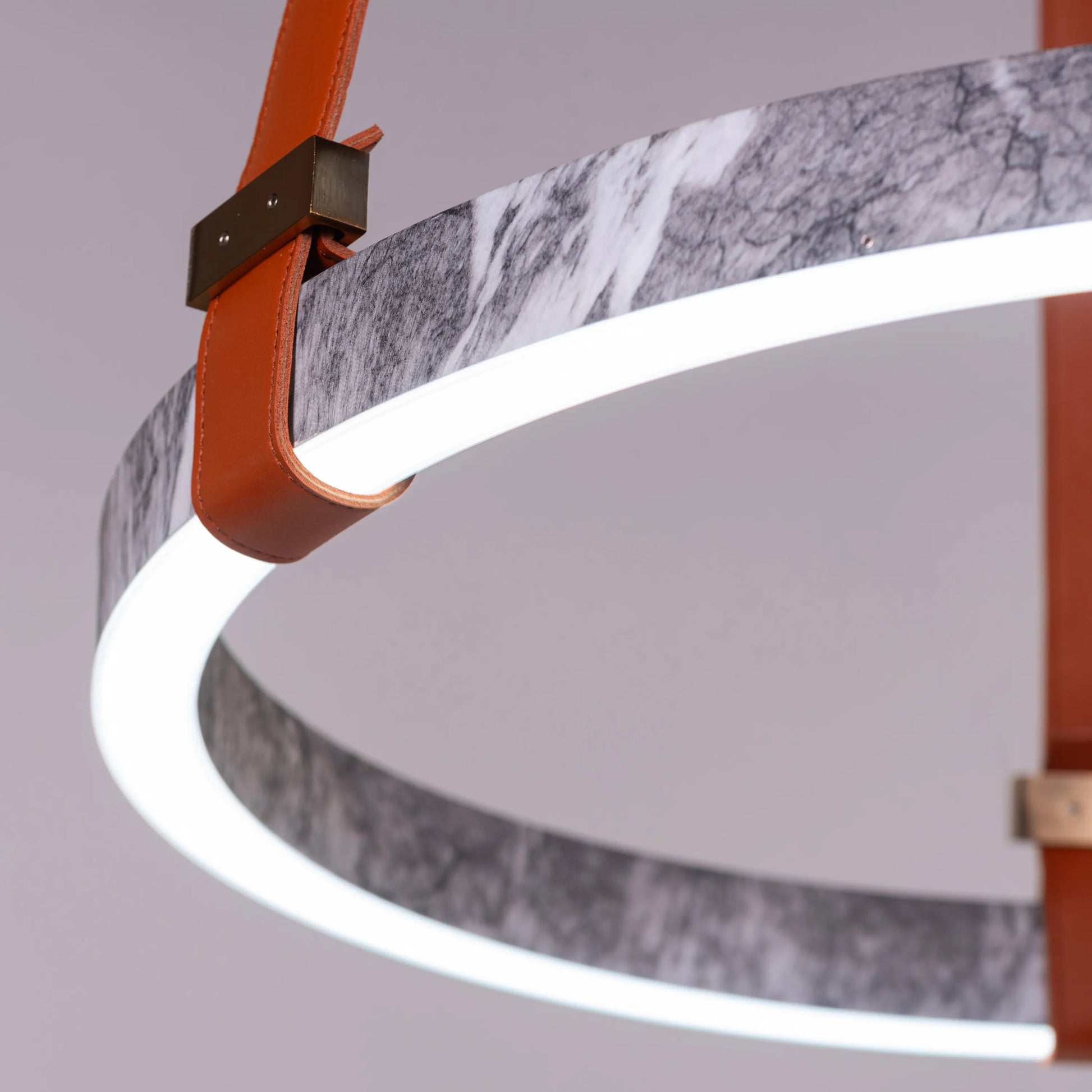 Round grey LED chandelier with slim profile suspended in a modern living room