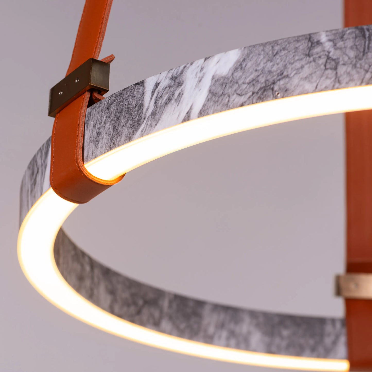 Round grey LED chandelier with slim profile suspended in a modern living room