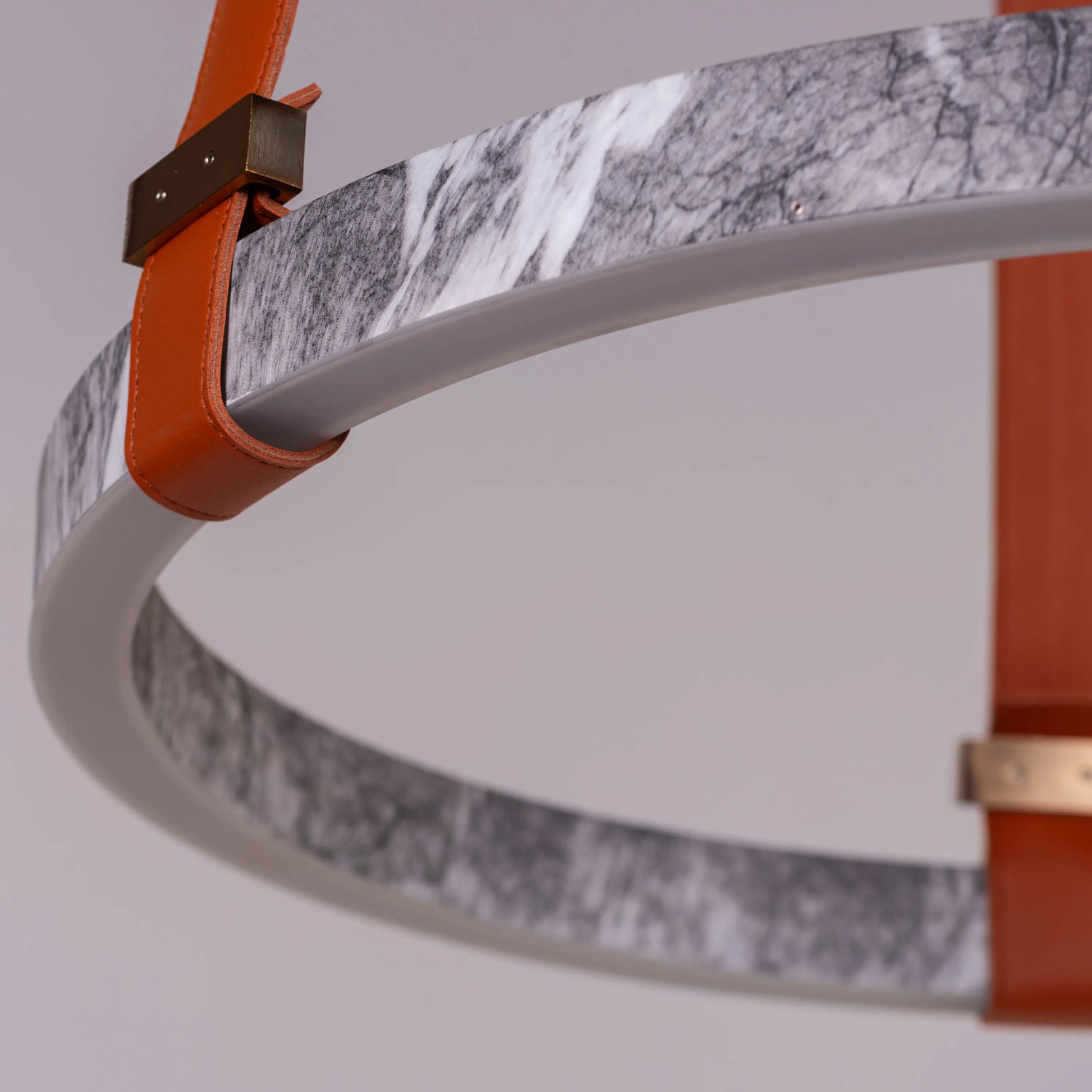 Round grey LED chandelier with slim profile suspended in a modern living room