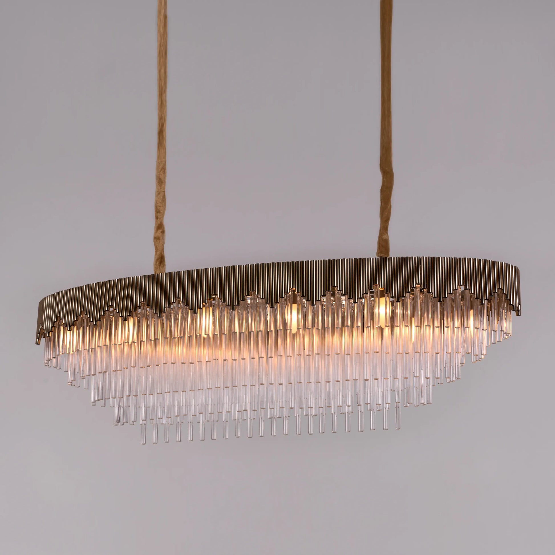 Diamonds Are Forever large oval gold crystal chandelier illuminating a grand ballroom