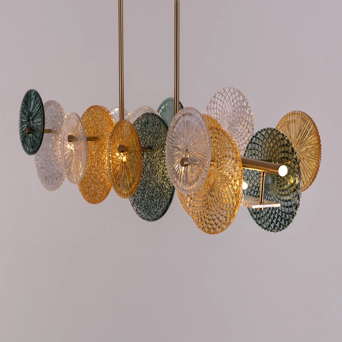 Large horizontal gold chandelier with textured surface in luxurious setting