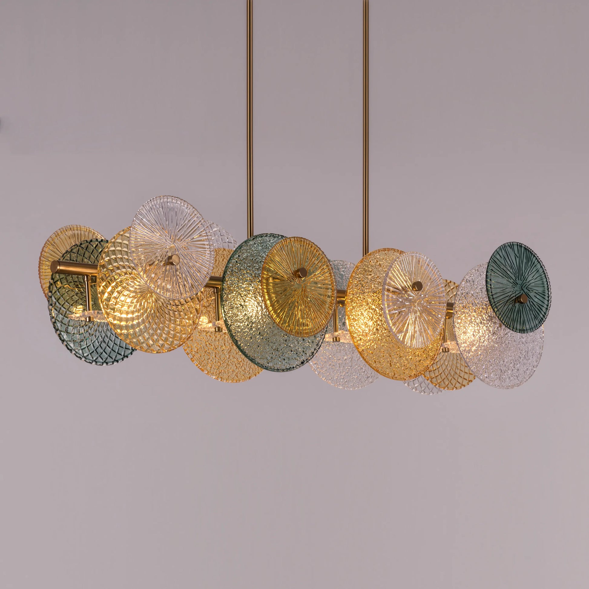 Large horizontal gold chandelier with textured surface in luxurious setting