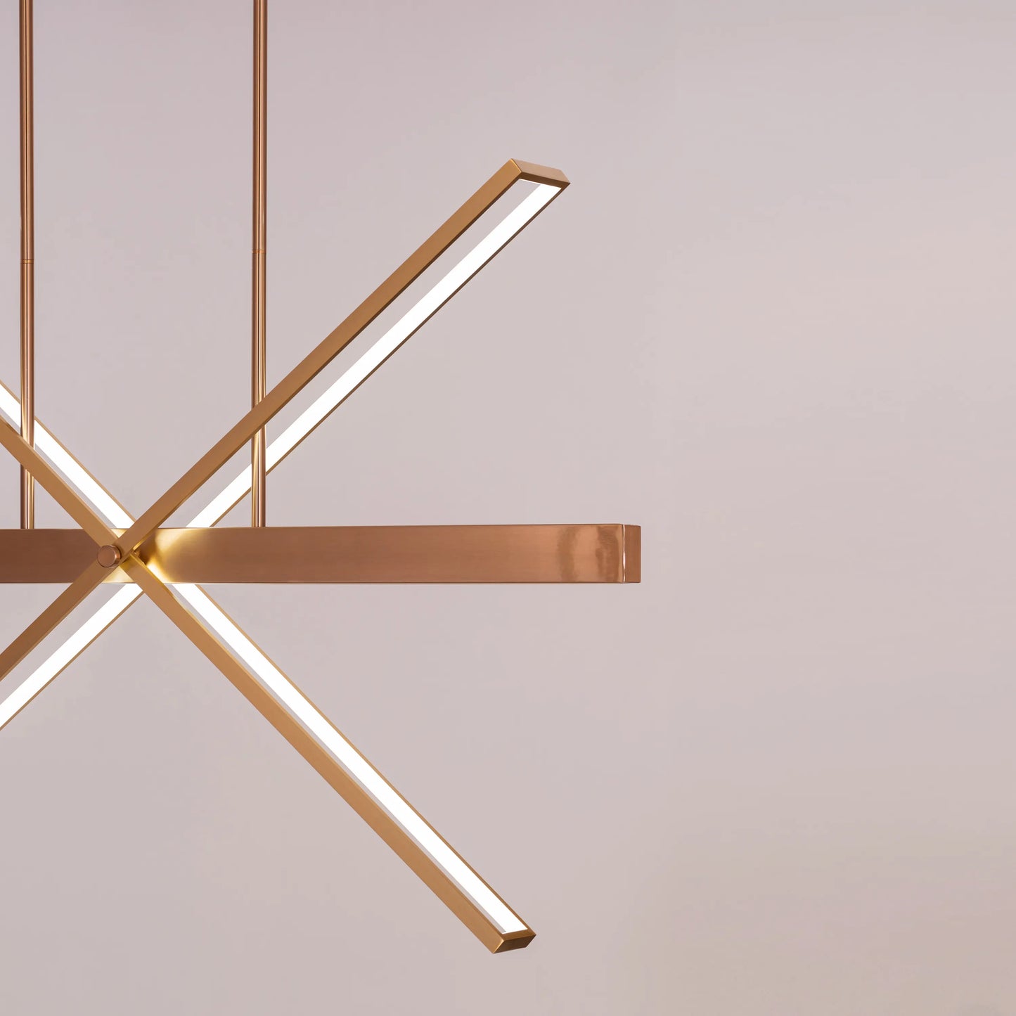 Large gold Pack Your Bags chandelier with dimmable LED lights illuminating a grand foyer