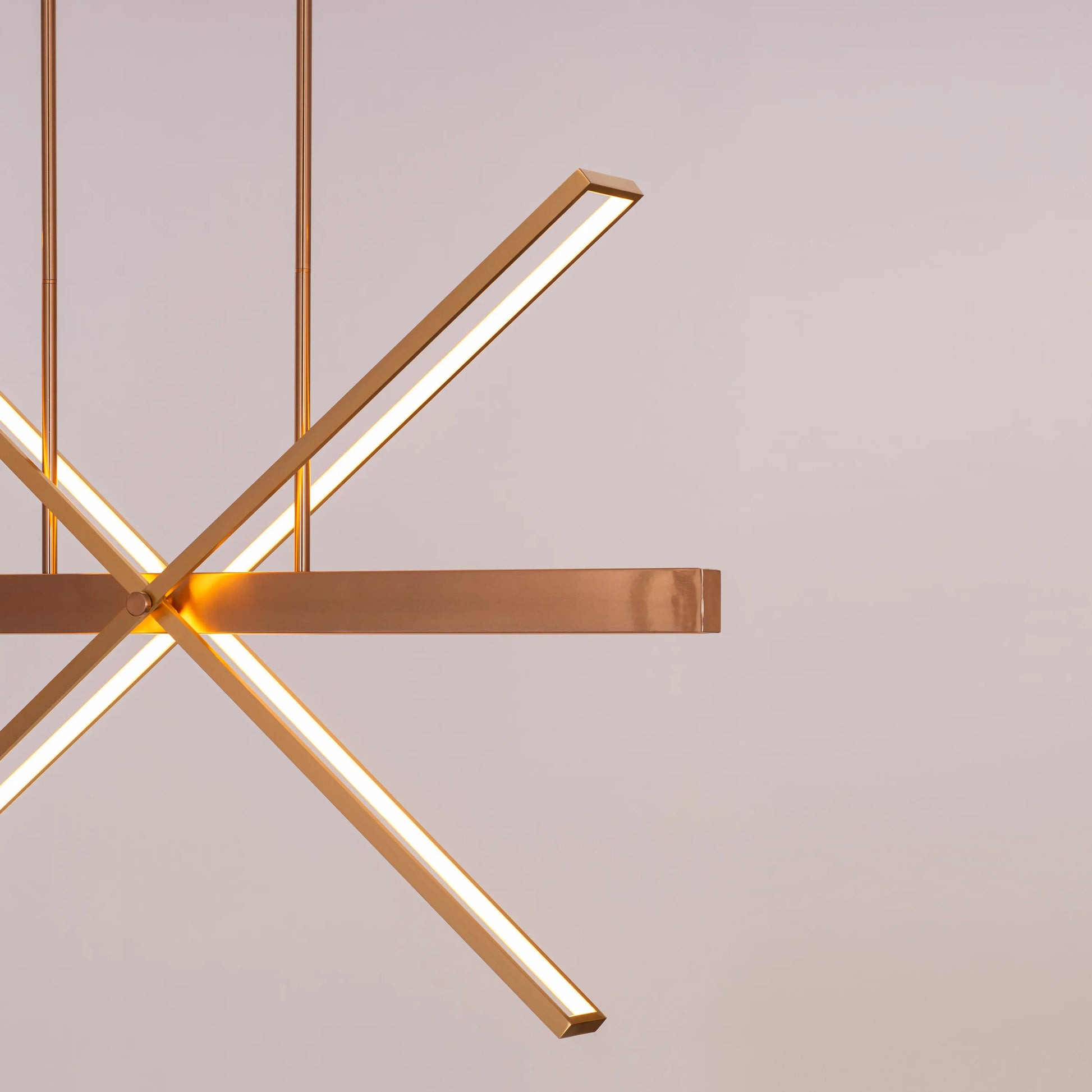 Large gold Pack Your Bags chandelier with dimmable LED lights illuminating a grand foyer