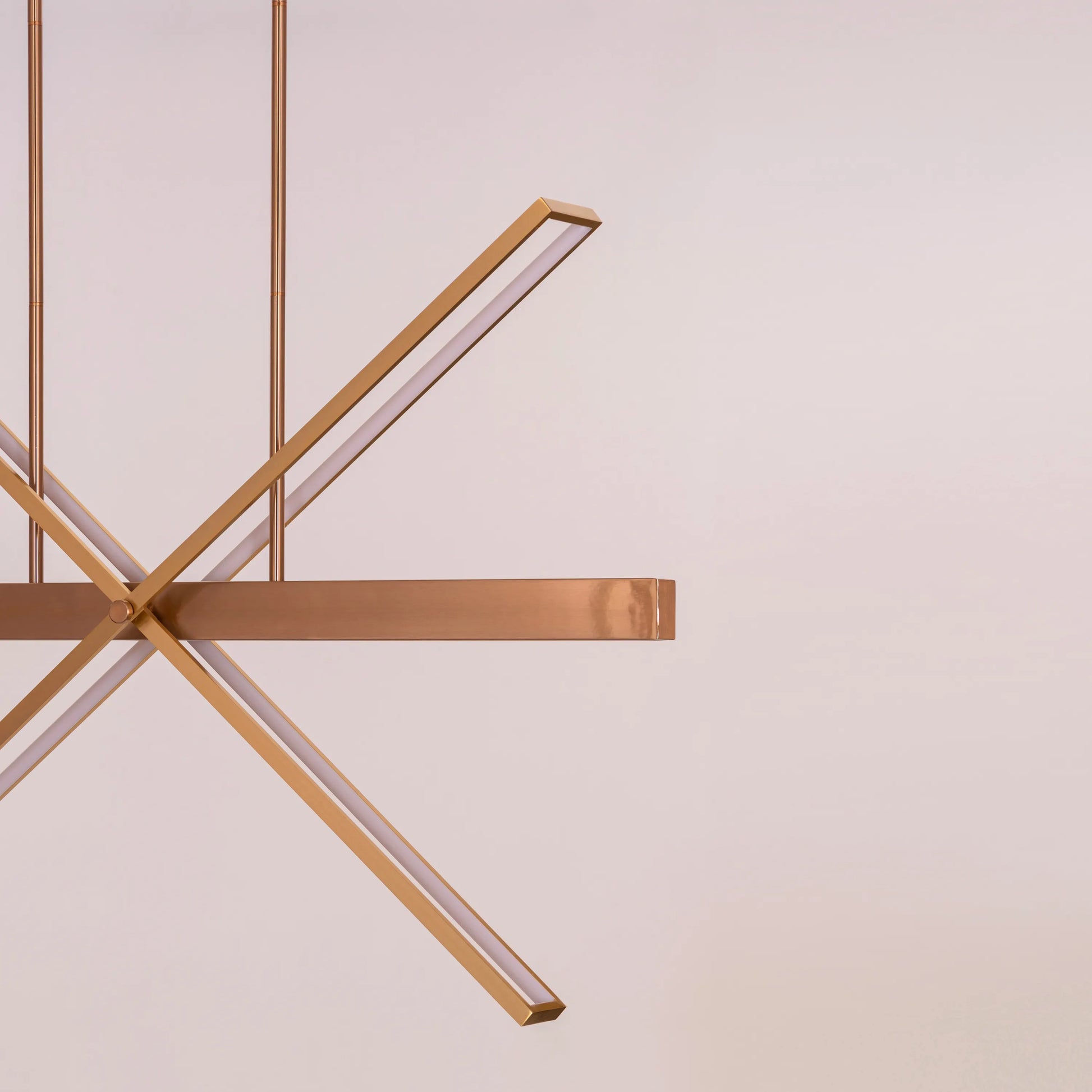 Large gold Pack Your Bags chandelier with dimmable LED lights illuminating a grand foyer