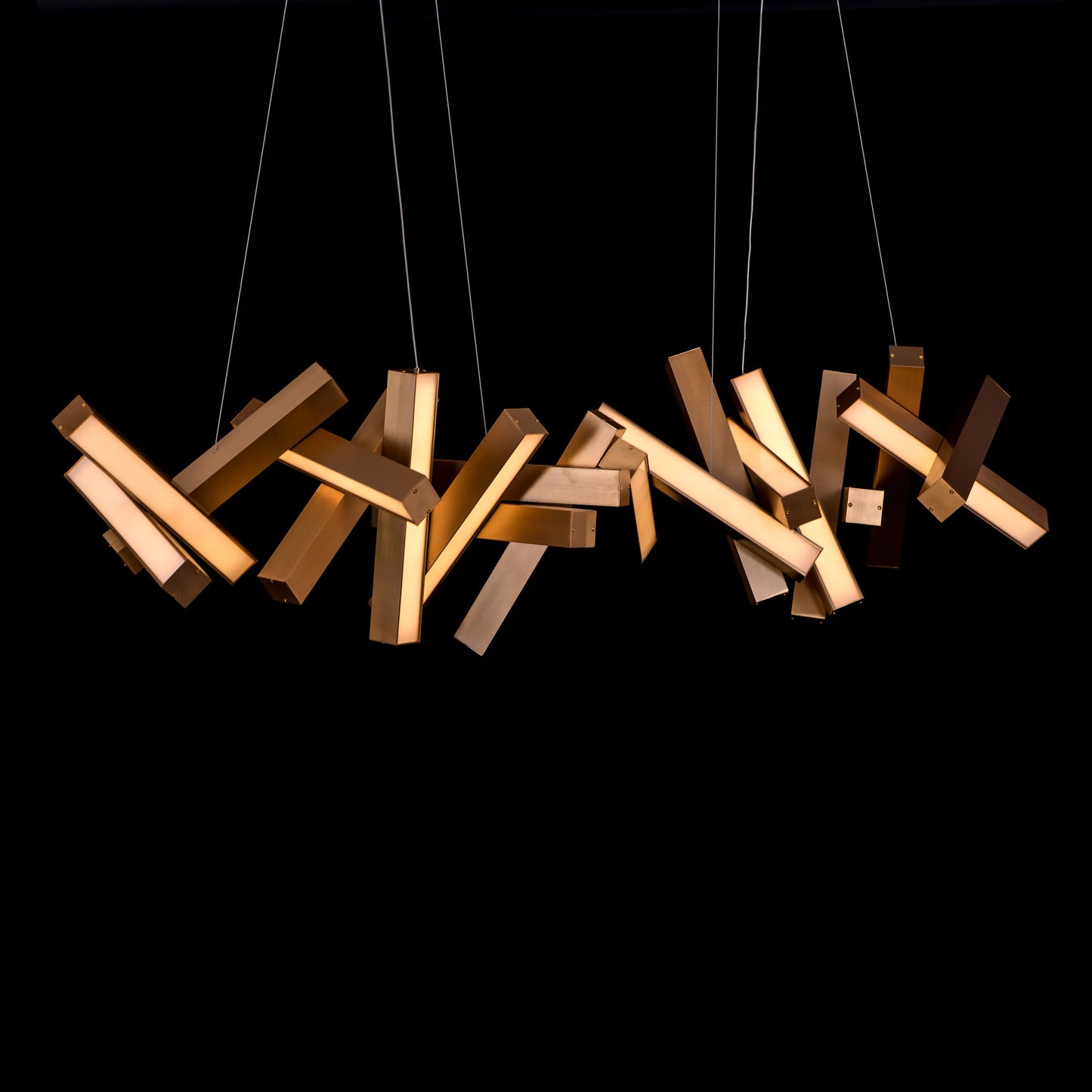 Large "Glow Miles" gold chandelier with multiple LED light sources, dramatically illuminated in a spacious, modern room.