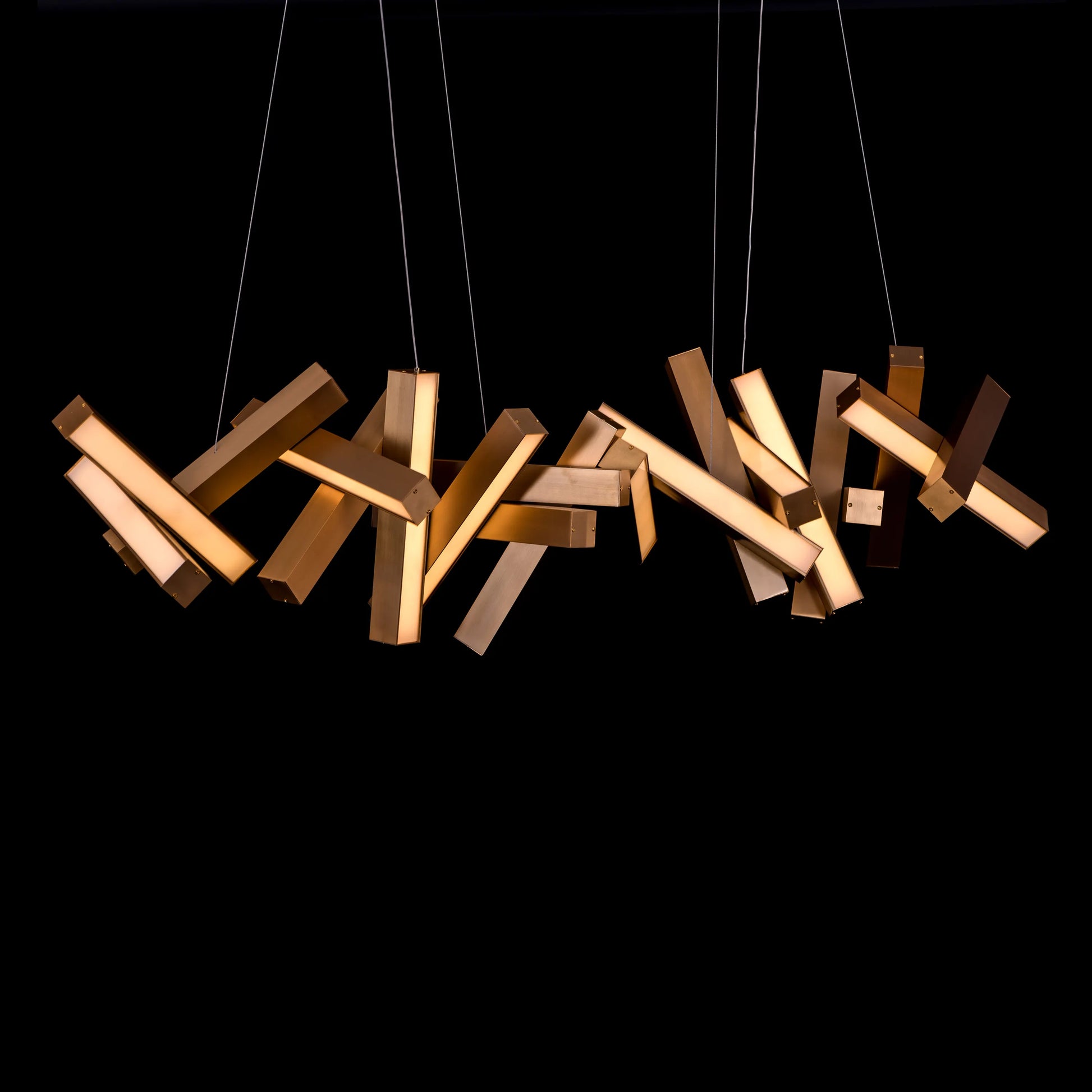 Large "Glow Miles" gold chandelier with multiple LED light sources, dramatically illuminated in a spacious, modern room.