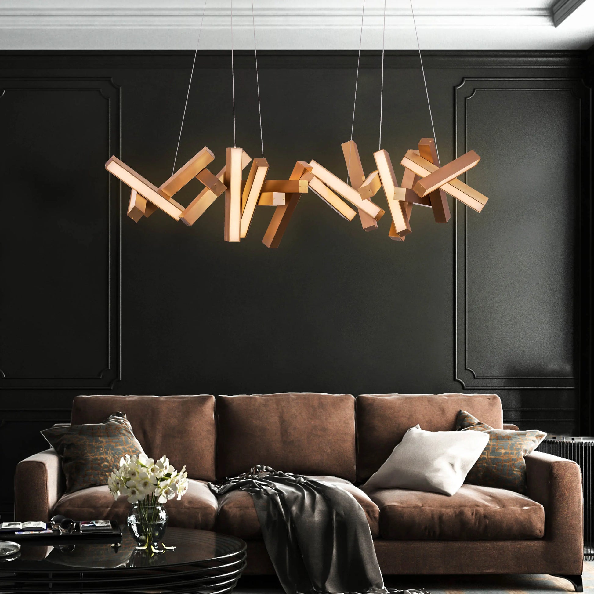 Large "Glow Miles" gold chandelier with multiple LED light sources, dramatically illuminated in a spacious, modern room.