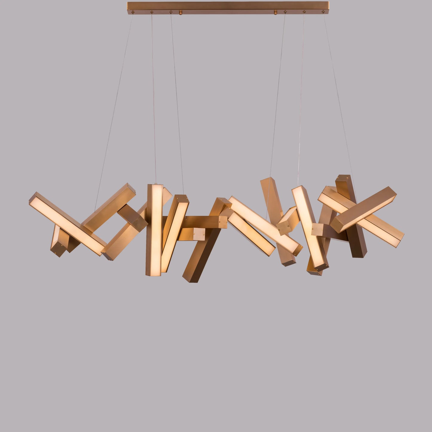 Large "Glow Miles" gold chandelier with multiple LED light sources, dramatically illuminated in a spacious, modern room.