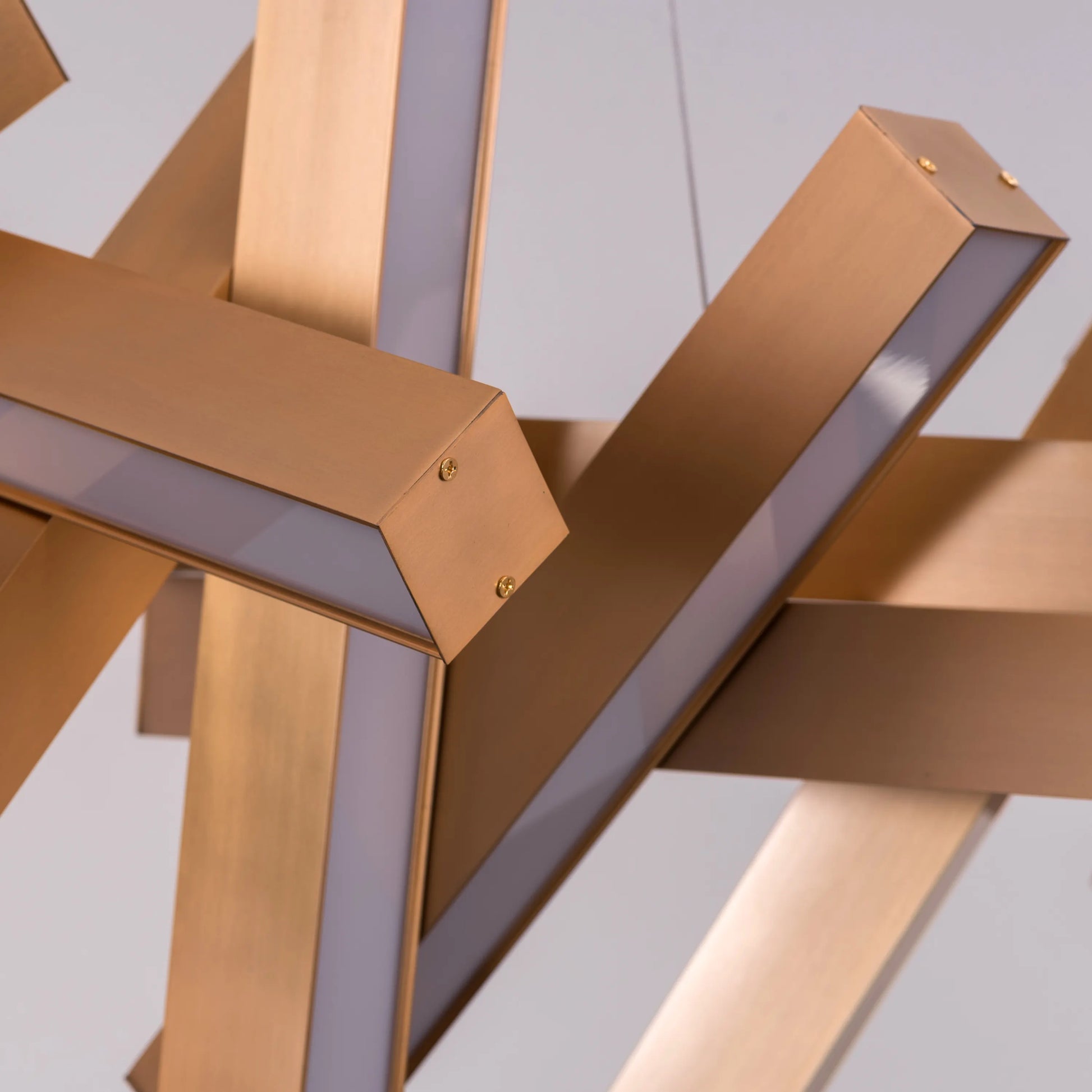 Large "Glow Miles" gold chandelier with multiple LED light sources, dramatically illuminated in a spacious, modern room.