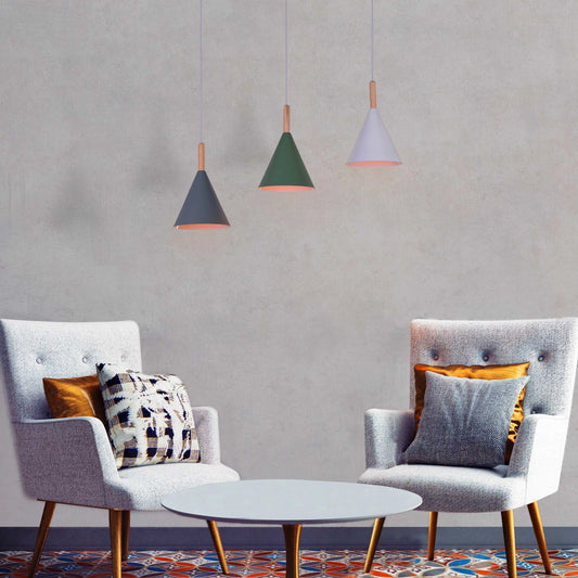 A vibrant pendant light named 'Bonus Points,' featuring three hanging heads in a playful combination of blue, green, and white. Each pendant has a smooth, minimalist design with sleek curves, creating a modern and cheerful aesthetic. The multi-colored arrangement adds a pop of color and a fun, dynamic vibe to any room.