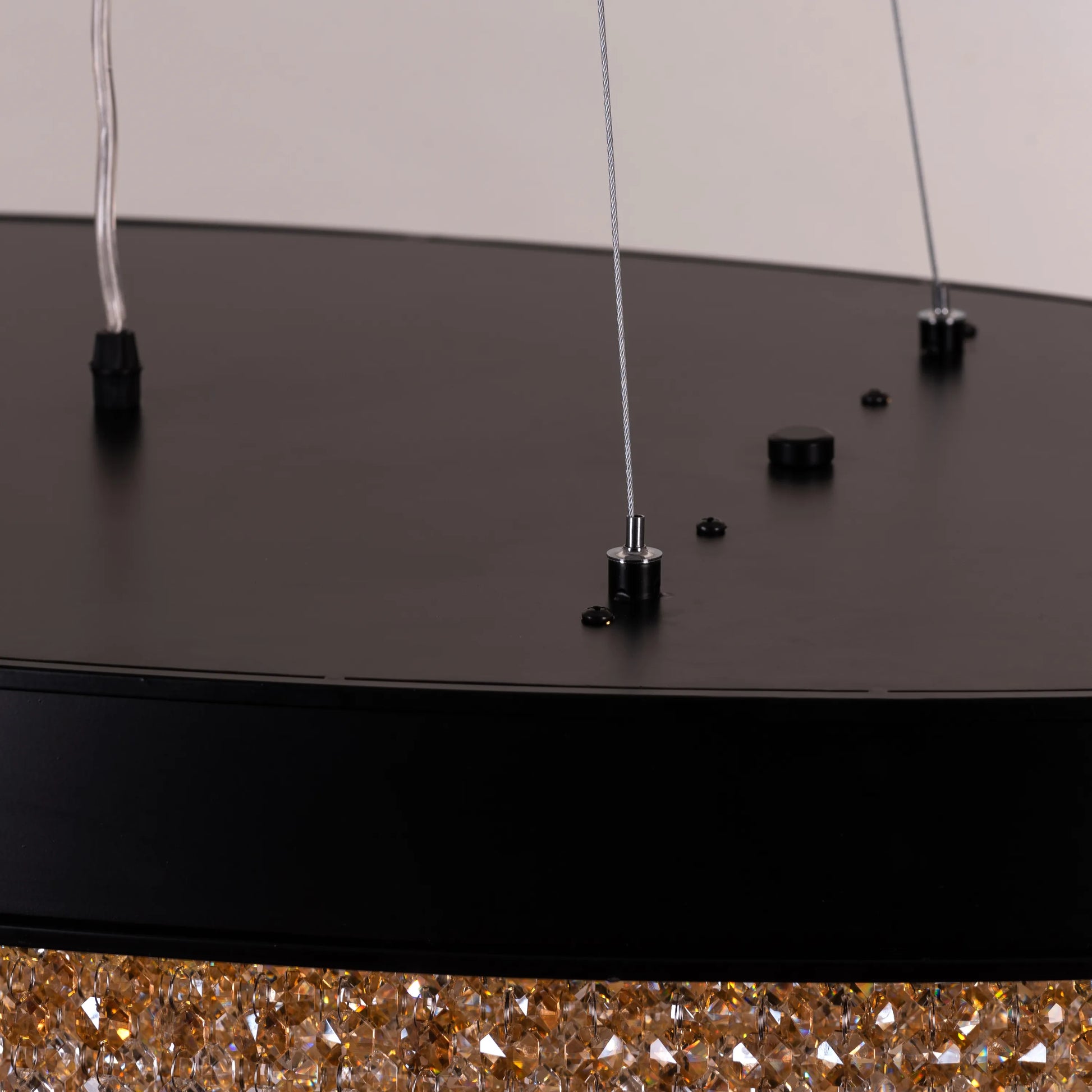 Close-up of Black Tie chandelier's intricate black frame and crystal details