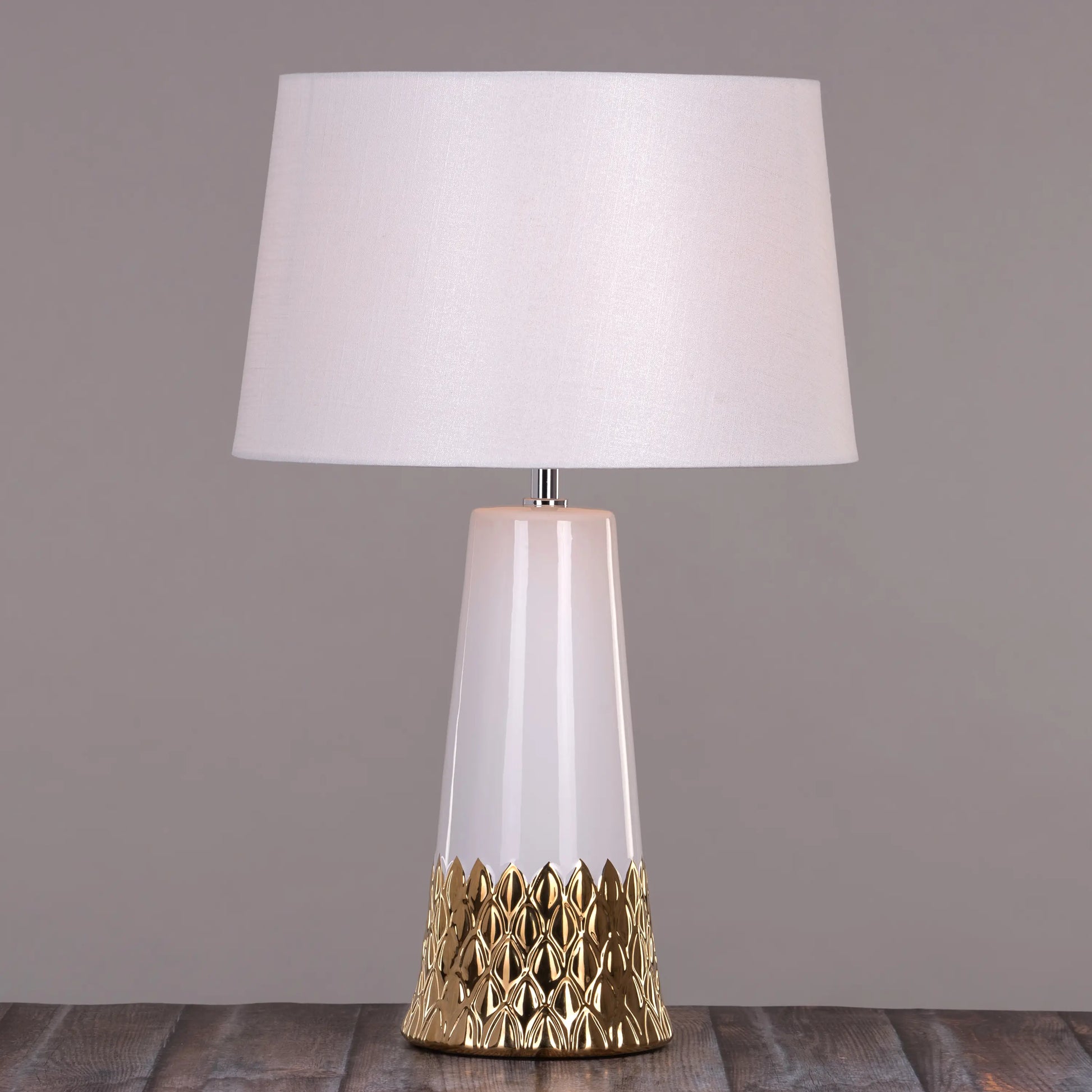 Warm and Inviting Glow from a White and Gold Ceramic Lamp