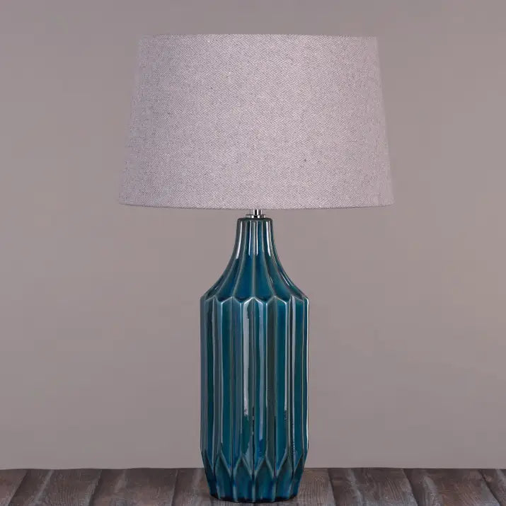 Neutral fabric shade on vibrant blue ceramic base