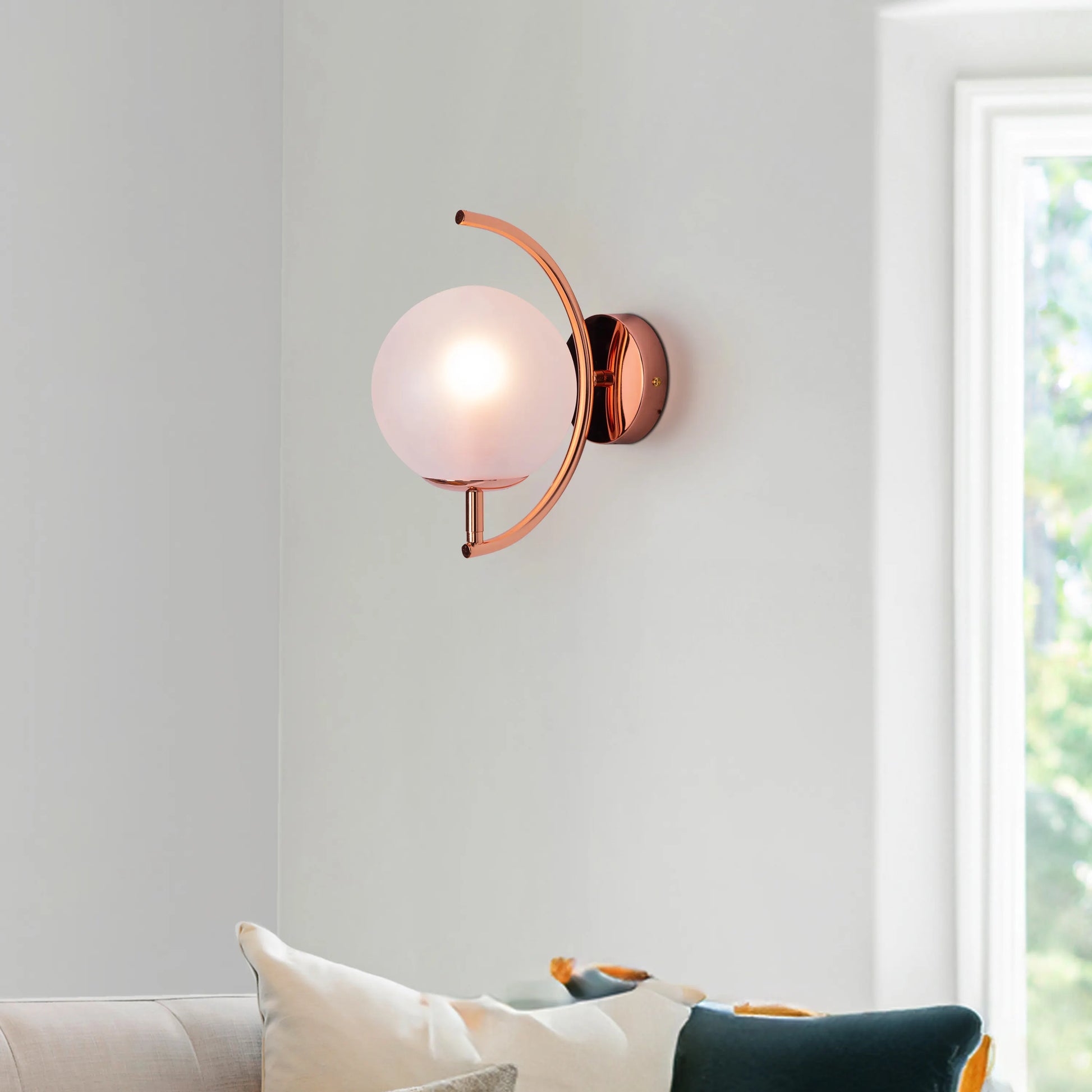 Show Me Love wall light casting a warm glow in a minimalist bedroom.