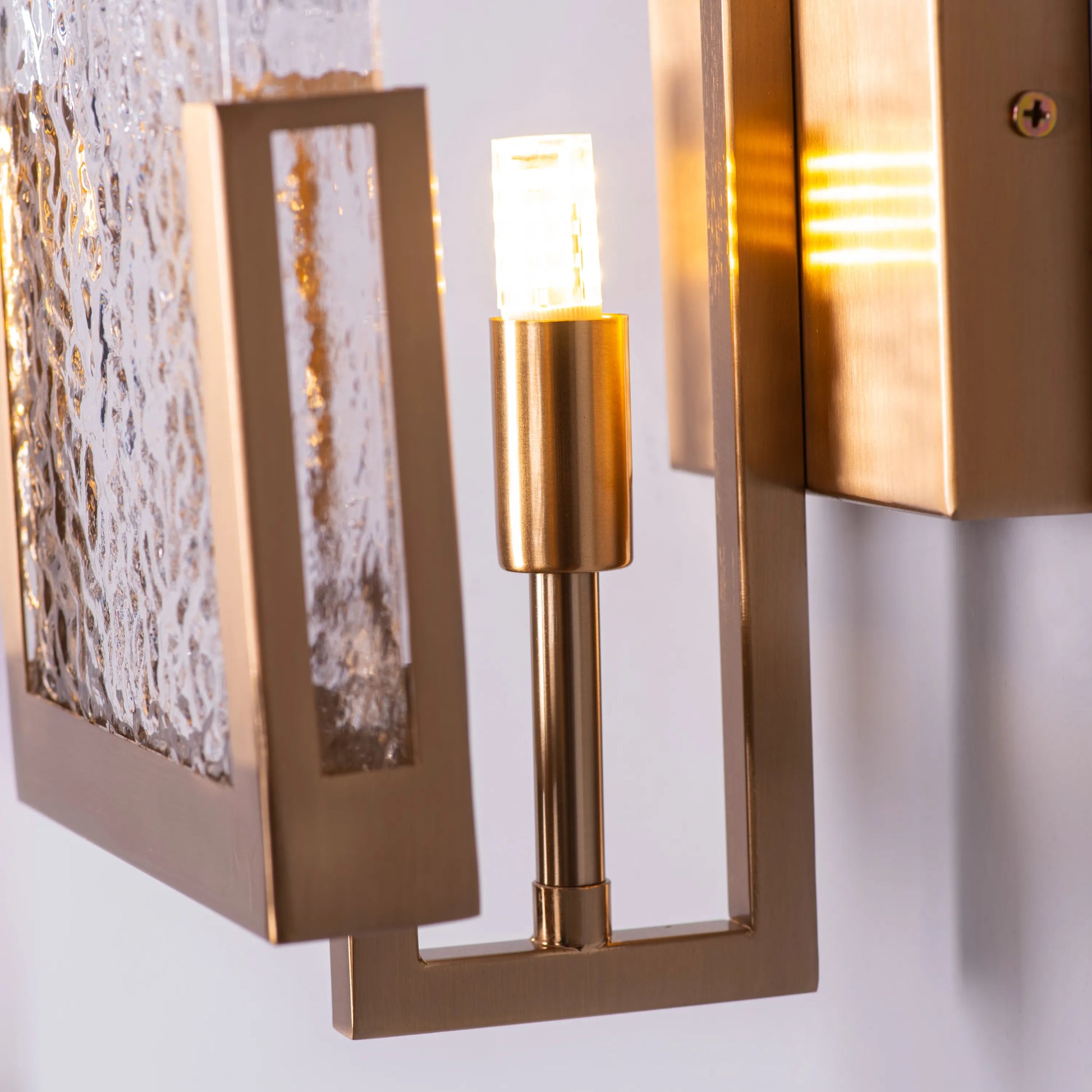 "Legacy Signature" Textured Glass Wall Light - A sleek, modern wall sconce with a textured glass shade that diffuses warm, glowing light.