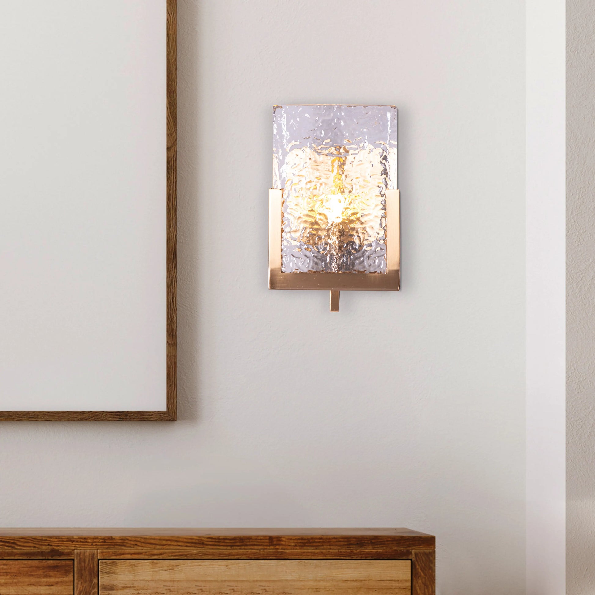 "Legacy Signature" Textured Glass Wall Light - A sleek, modern wall sconce with a textured glass shade that diffuses warm, glowing light.