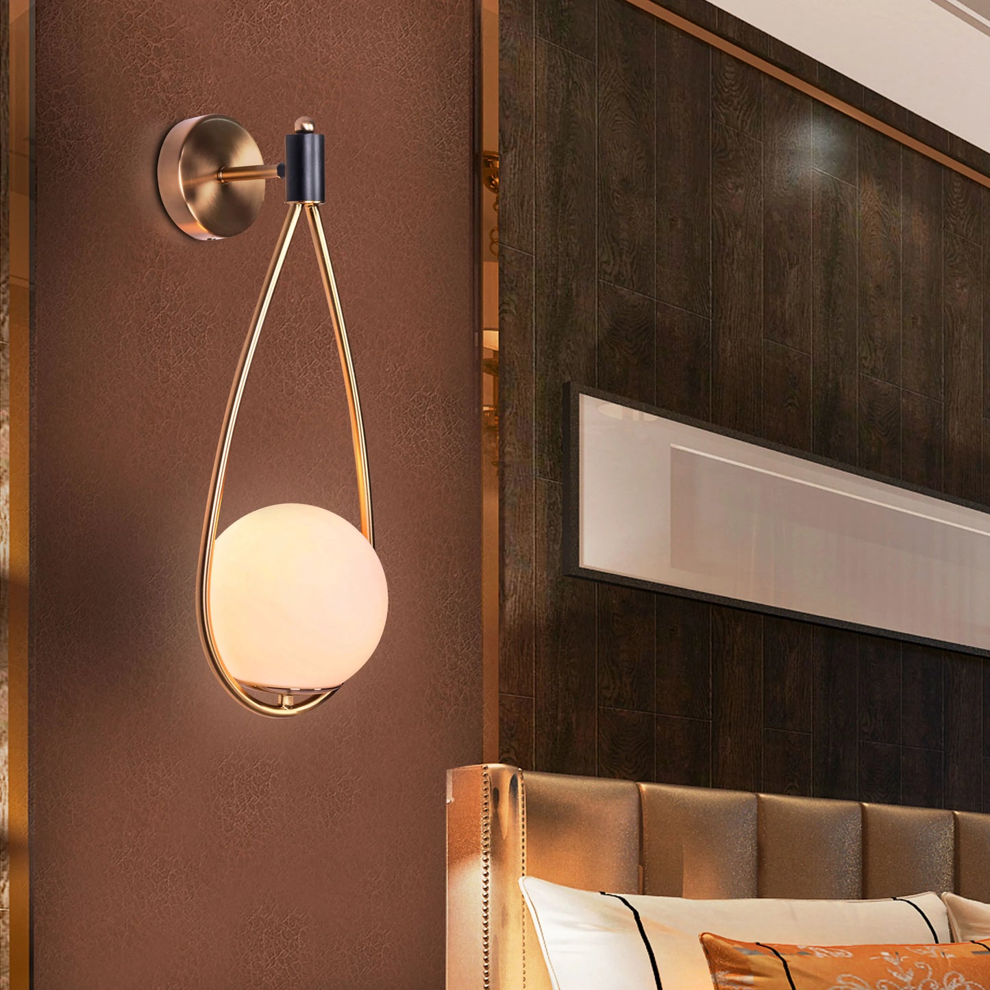 Sleek glass and metal wall light adding warmth to a minimalist living room.
