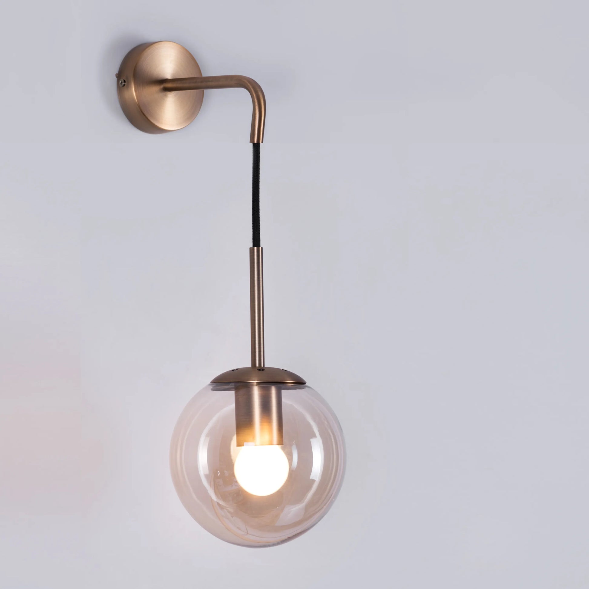 Elevated Glass Wall Light – minimalist wall light with clear glass design, providing warm, ambient lighting for sophisticated and modern interiors.