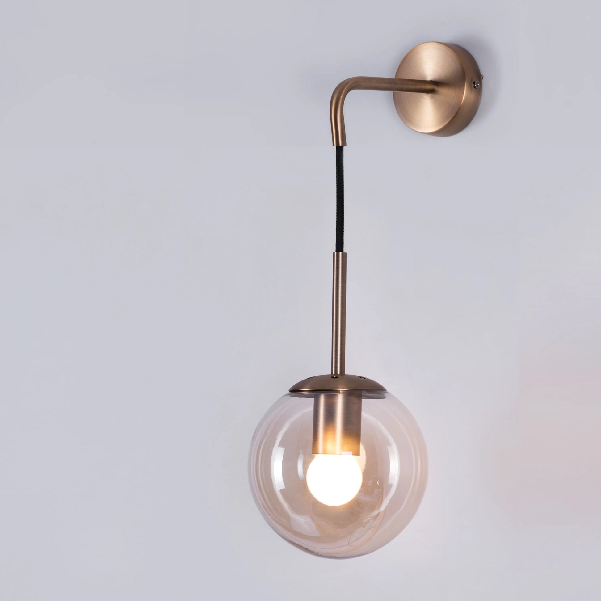 Elevated Glass Wall Light – minimalist wall light with clear glass design, providing warm, ambient lighting for sophisticated and modern interiors.