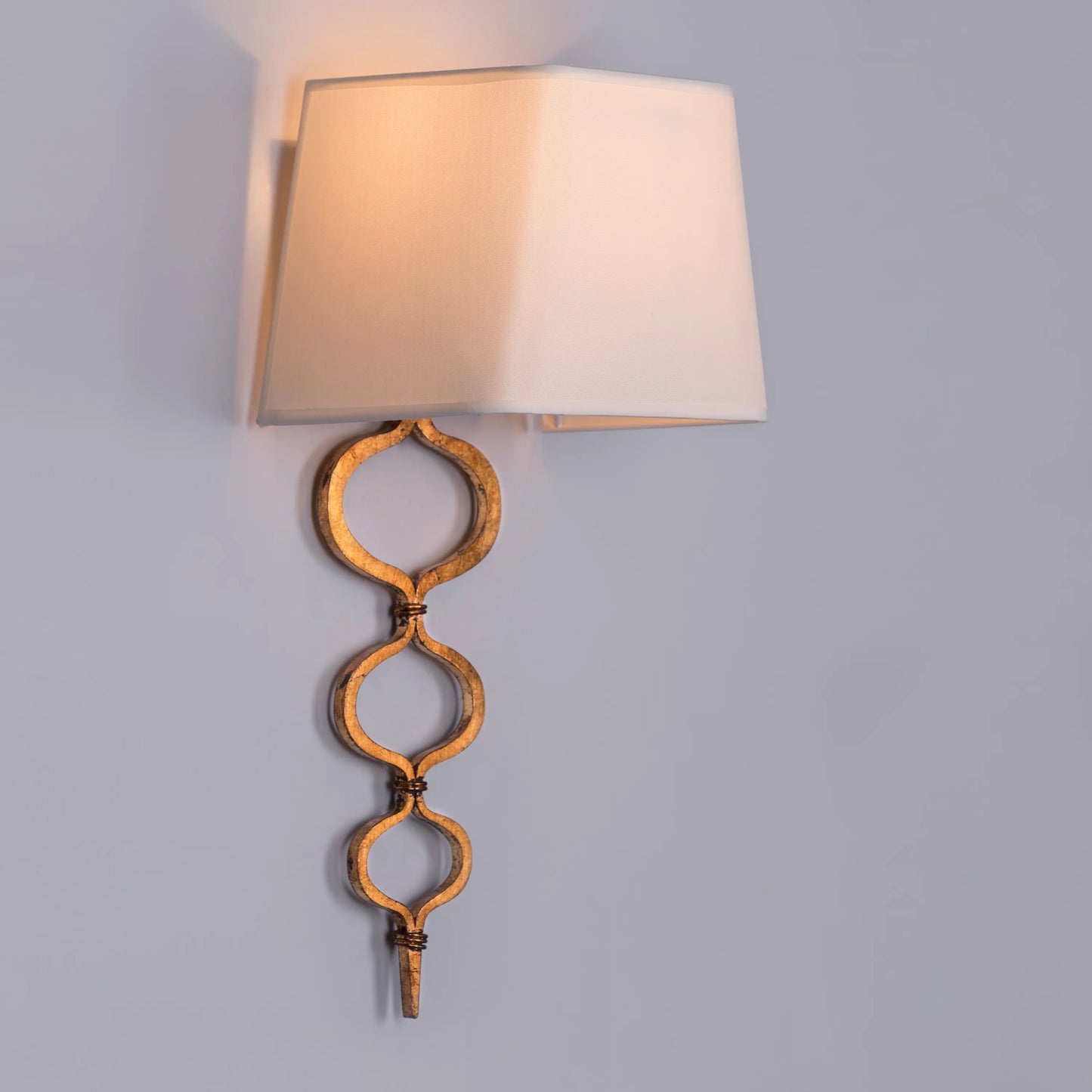 Elegant wall light with a warm, sunlit glow and gold finish; perfect for creating cozy ambiance in bedrooms and living areas.
