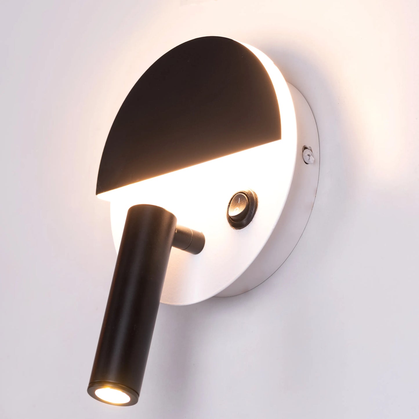 Elegant Elated Wall Light featuring a geometric layered design in brushed metal finish, projecting warm ambient light through crystal-clear glass elements against a neutral wall