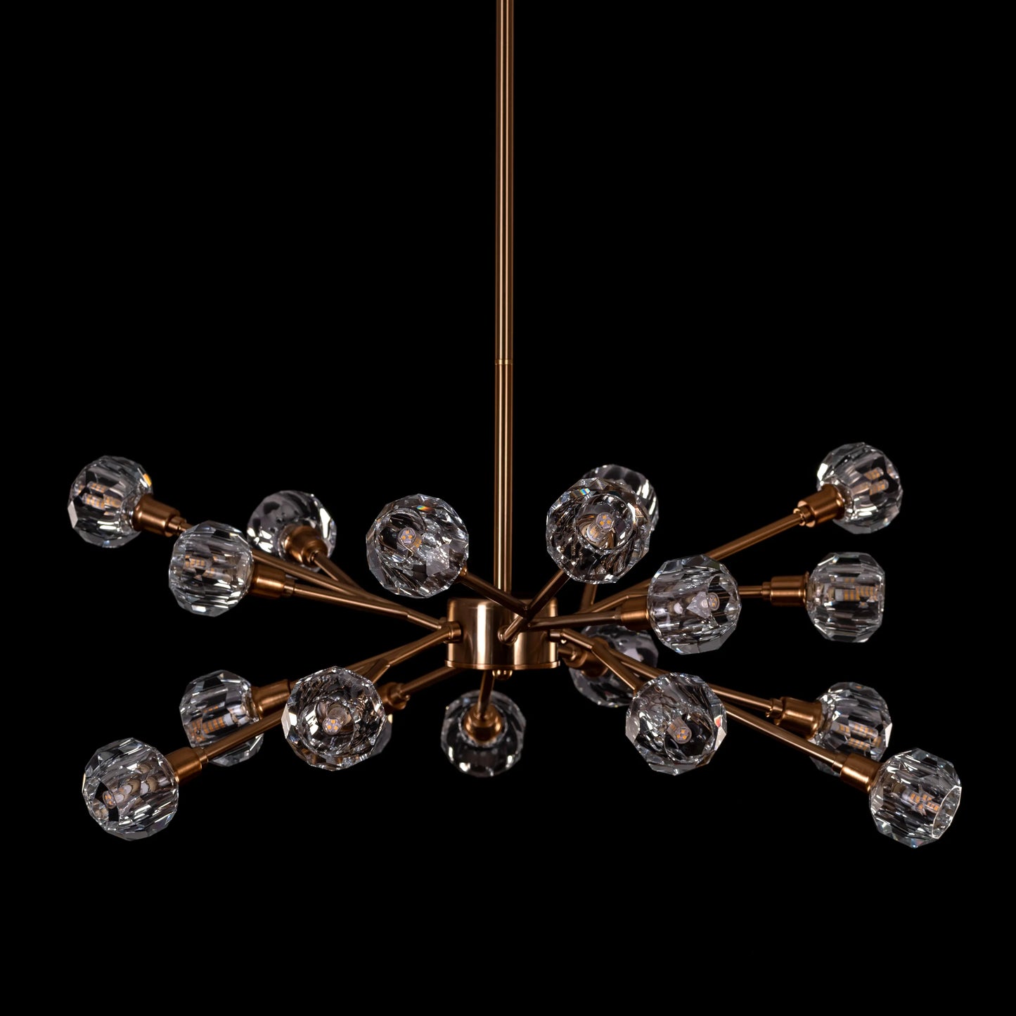 Queen's Necklace medium gold and crystal chandelier illuminating an elegant dining room with its warm, sparkling glow
