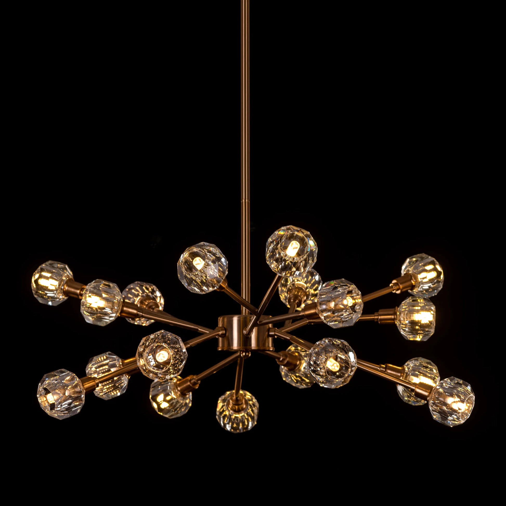 Queen's Necklace medium gold and crystal chandelier illuminating an elegant dining room with its warm, sparkling glow