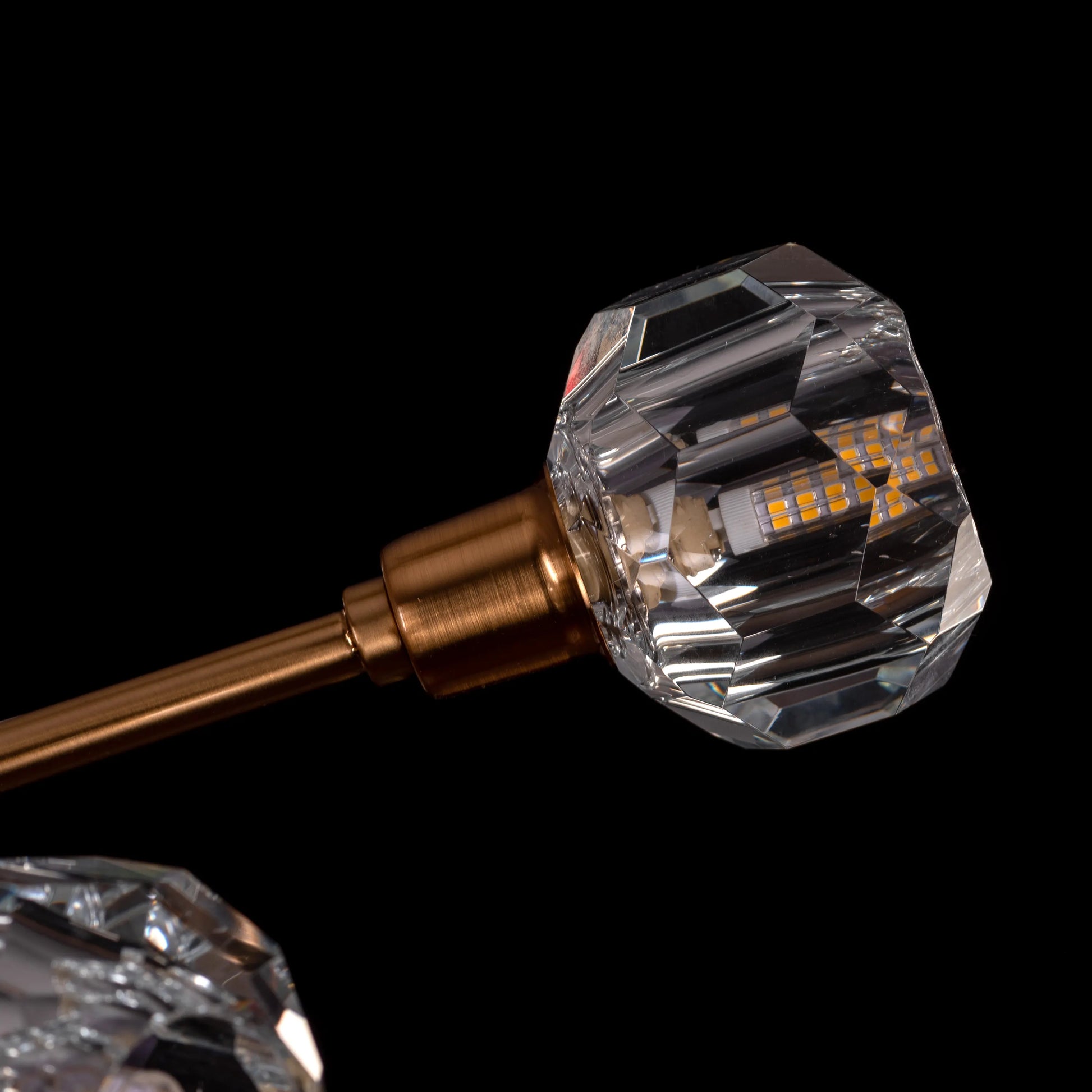 Queen's Necklace medium gold and crystal chandelier illuminating an elegant dining room with its warm, sparkling glow