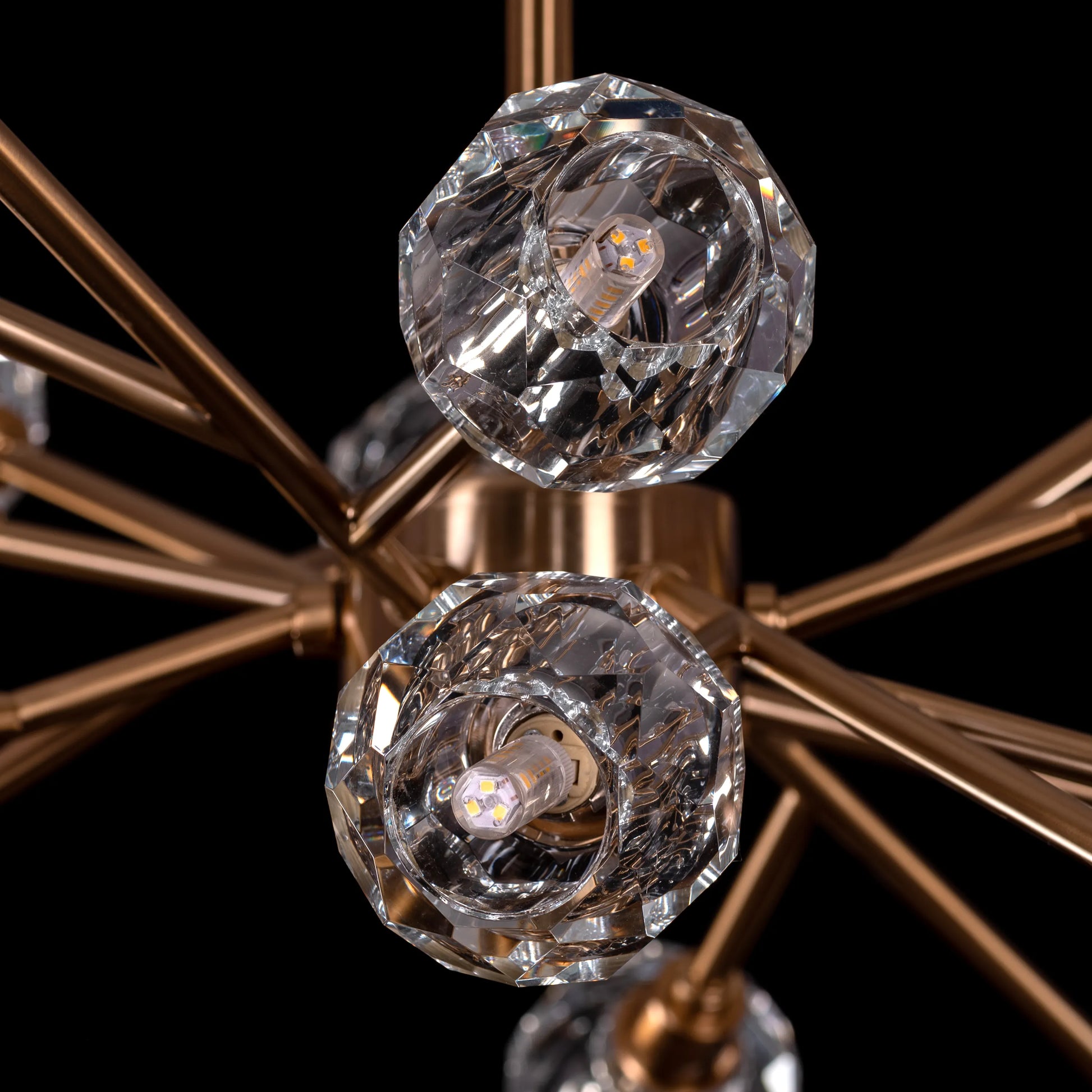 Queen's Necklace medium gold and crystal chandelier illuminating an elegant dining room with its warm, sparkling glow