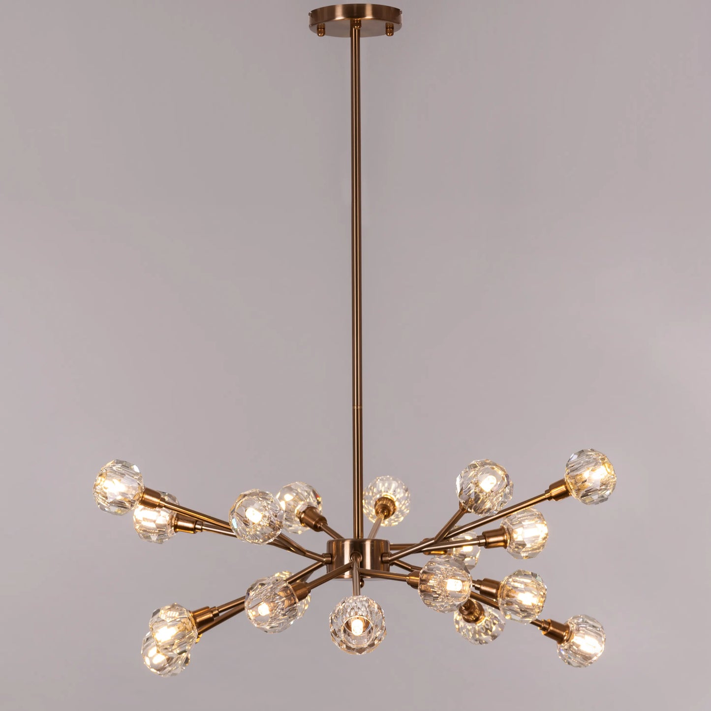 Queen's Necklace medium gold and crystal chandelier illuminating an elegant dining room with its warm, sparkling glow