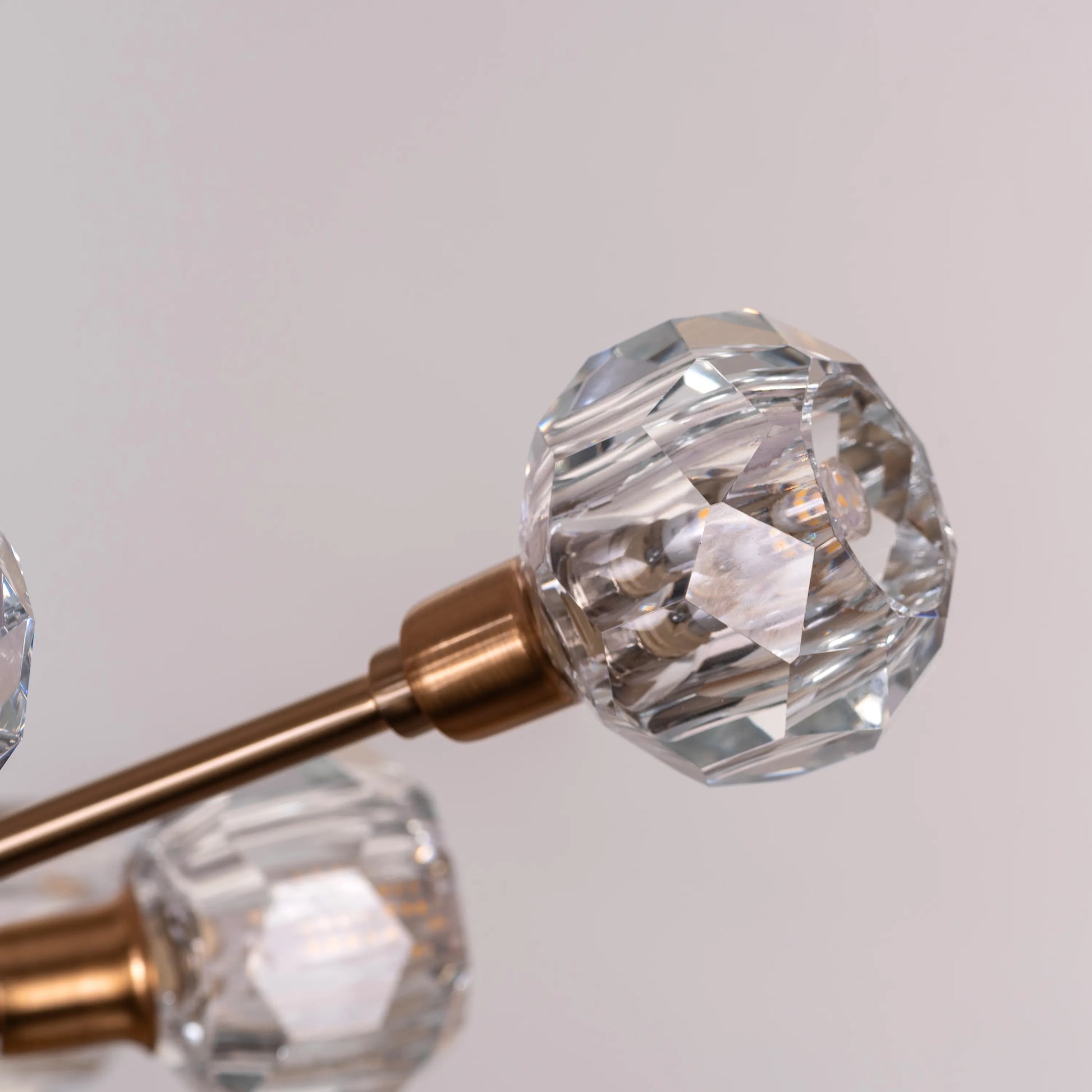 Queen's Necklace medium gold and crystal chandelier illuminating an elegant dining room with its warm, sparkling glow